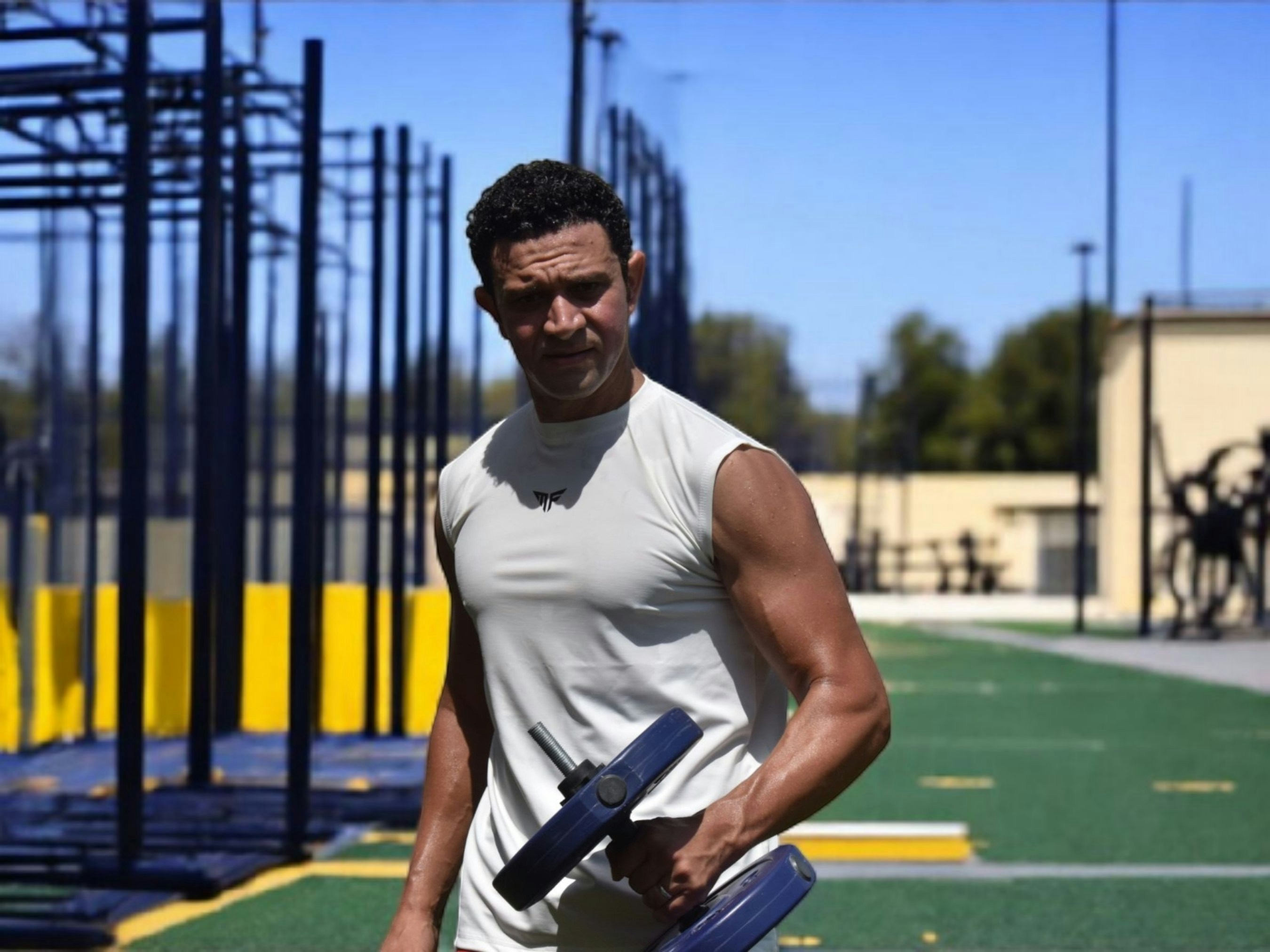 Man holding dumbbells at outdoor gym