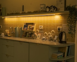 A kitchen counter with tea supplies and kettle.
