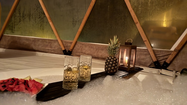 Two glasses of champagne with pineapple and lantern