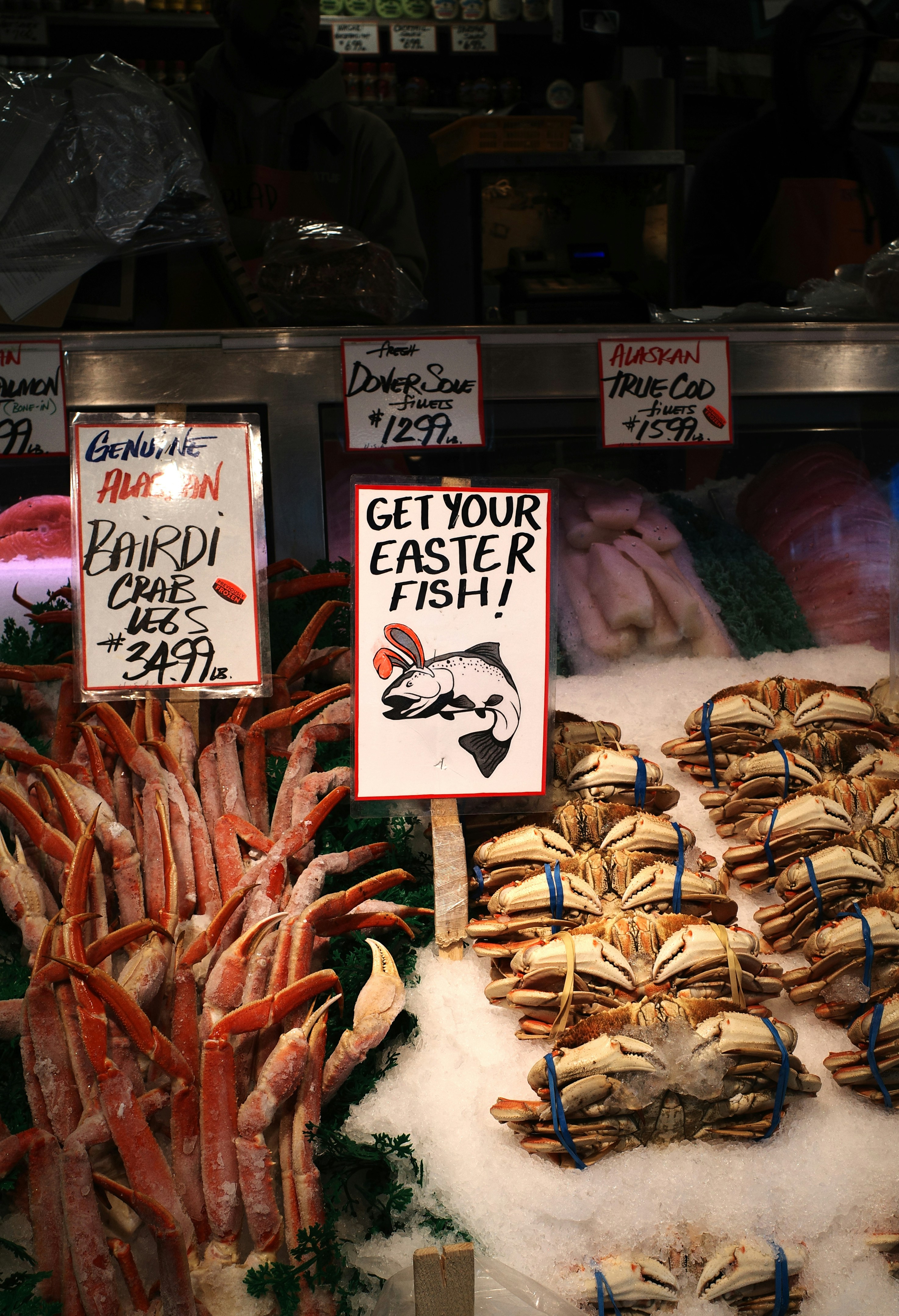 Fresh seafood display with crabs and crab legs.