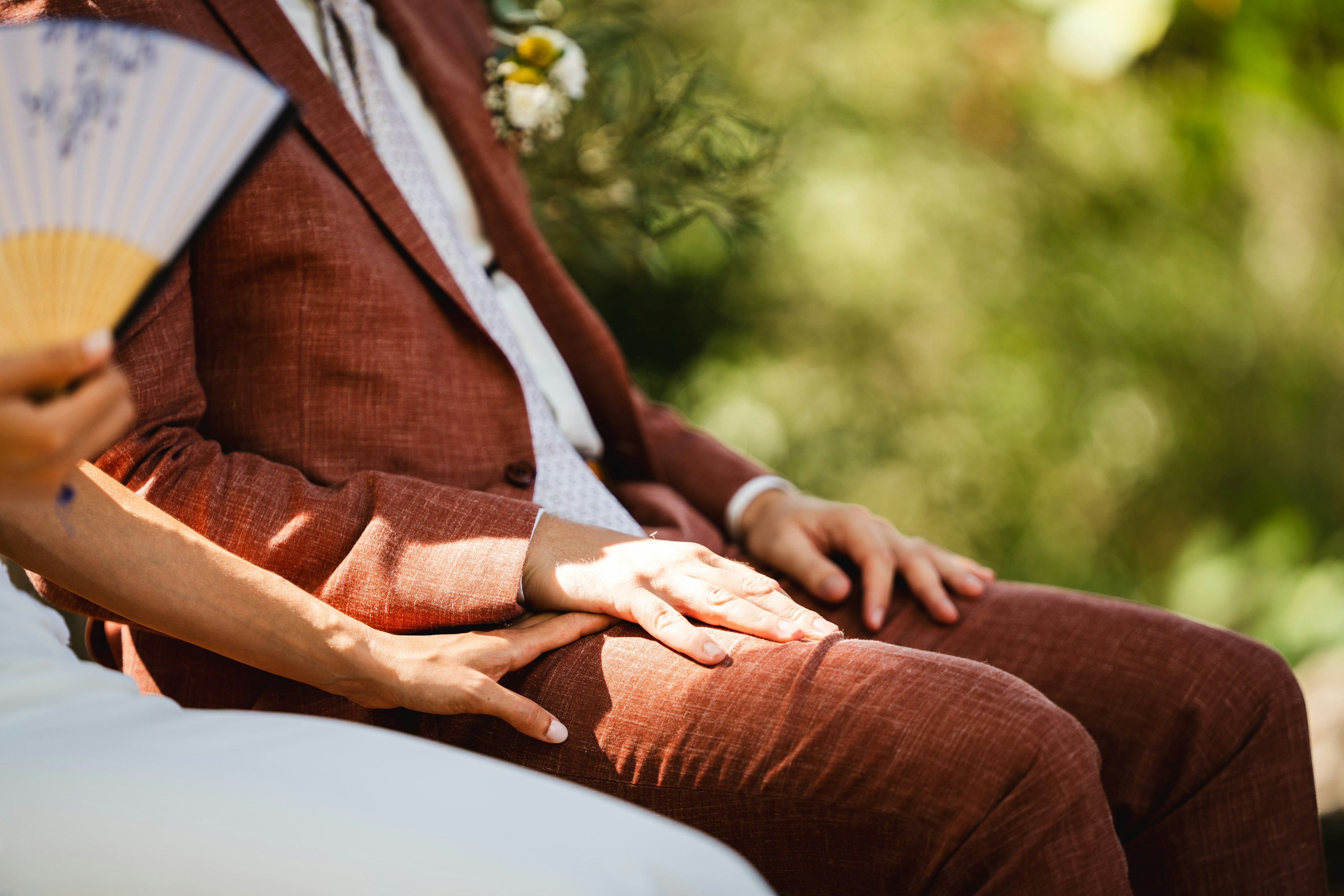 Couple holding hands during outdoor ceremony