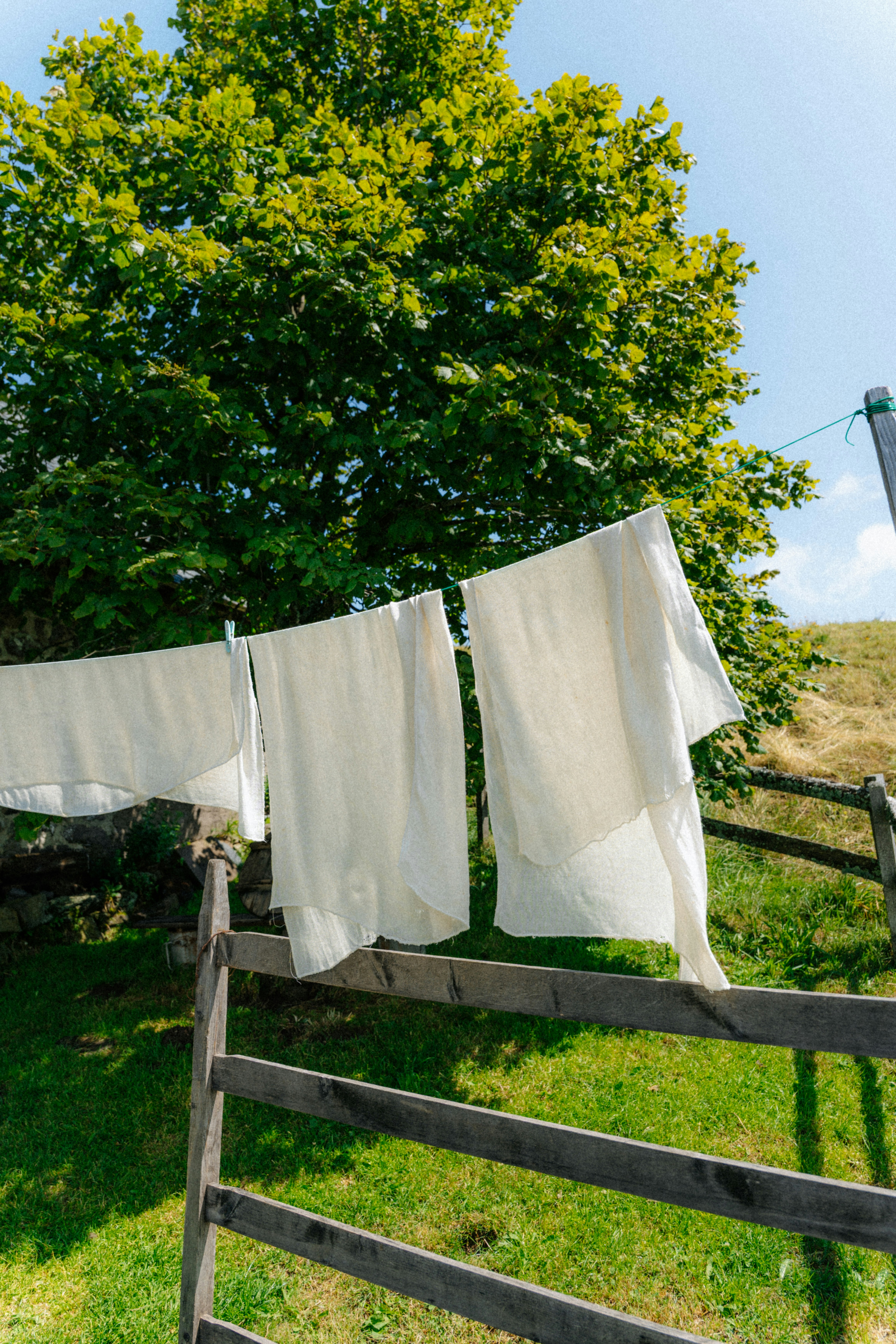 White laundry drying on a clothesline outdoors.