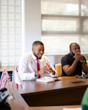 Two men in a meeting at a conference table.