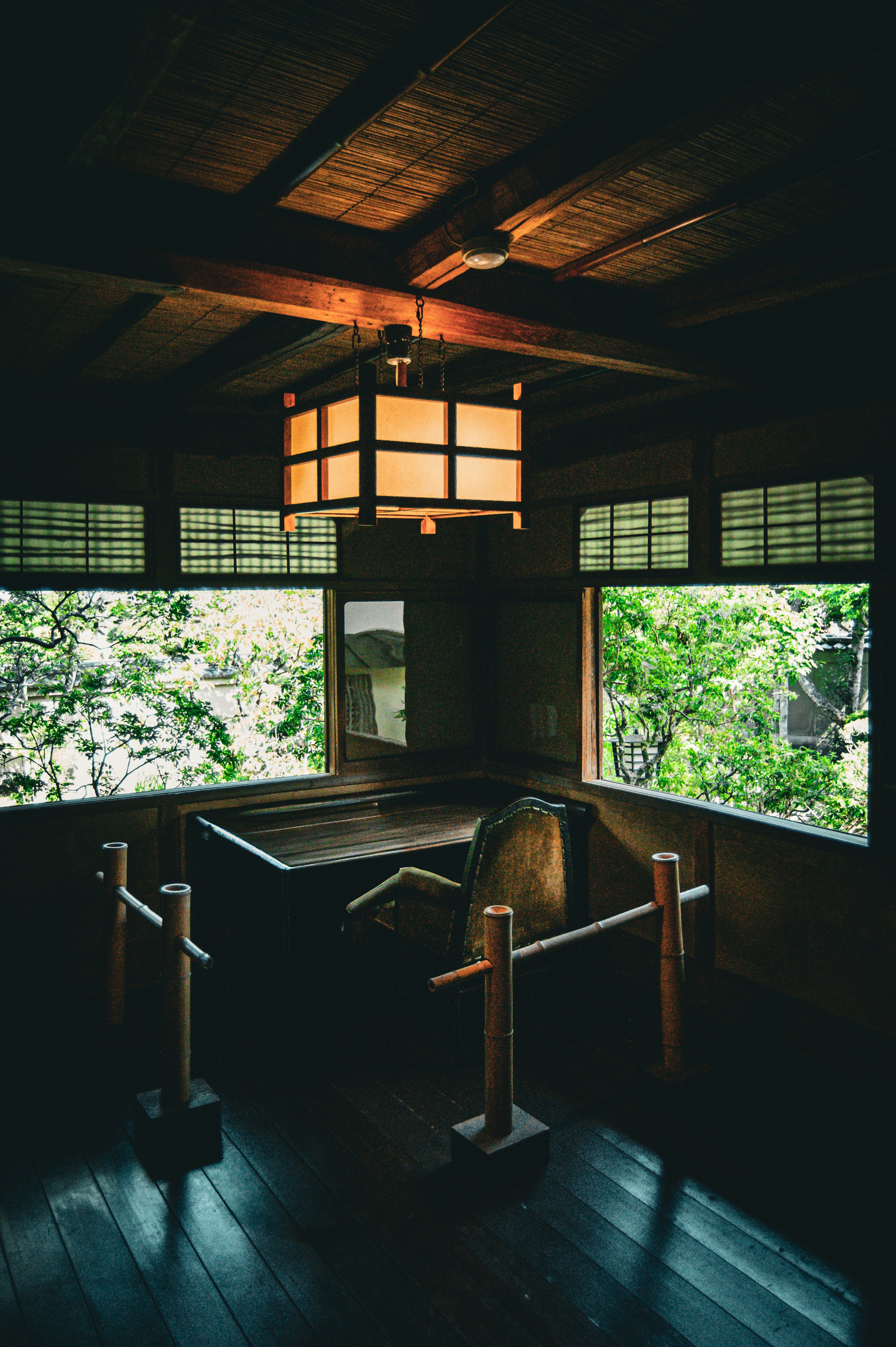 Traditional japanese room with garden view and lantern.