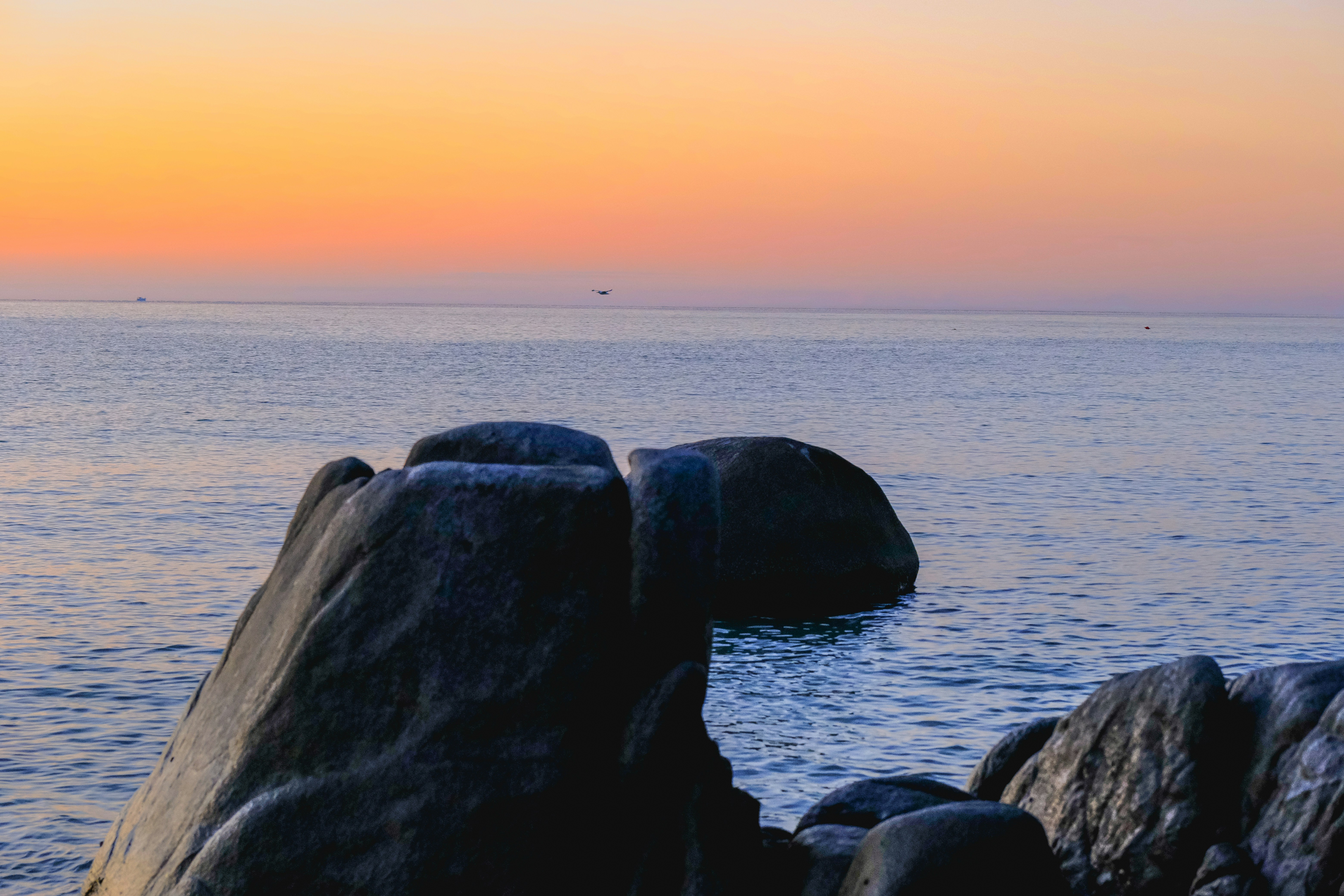 Large rocks in the ocean at sunset
