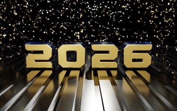 Golden 2026 numerals on a reflective surface with confetti.