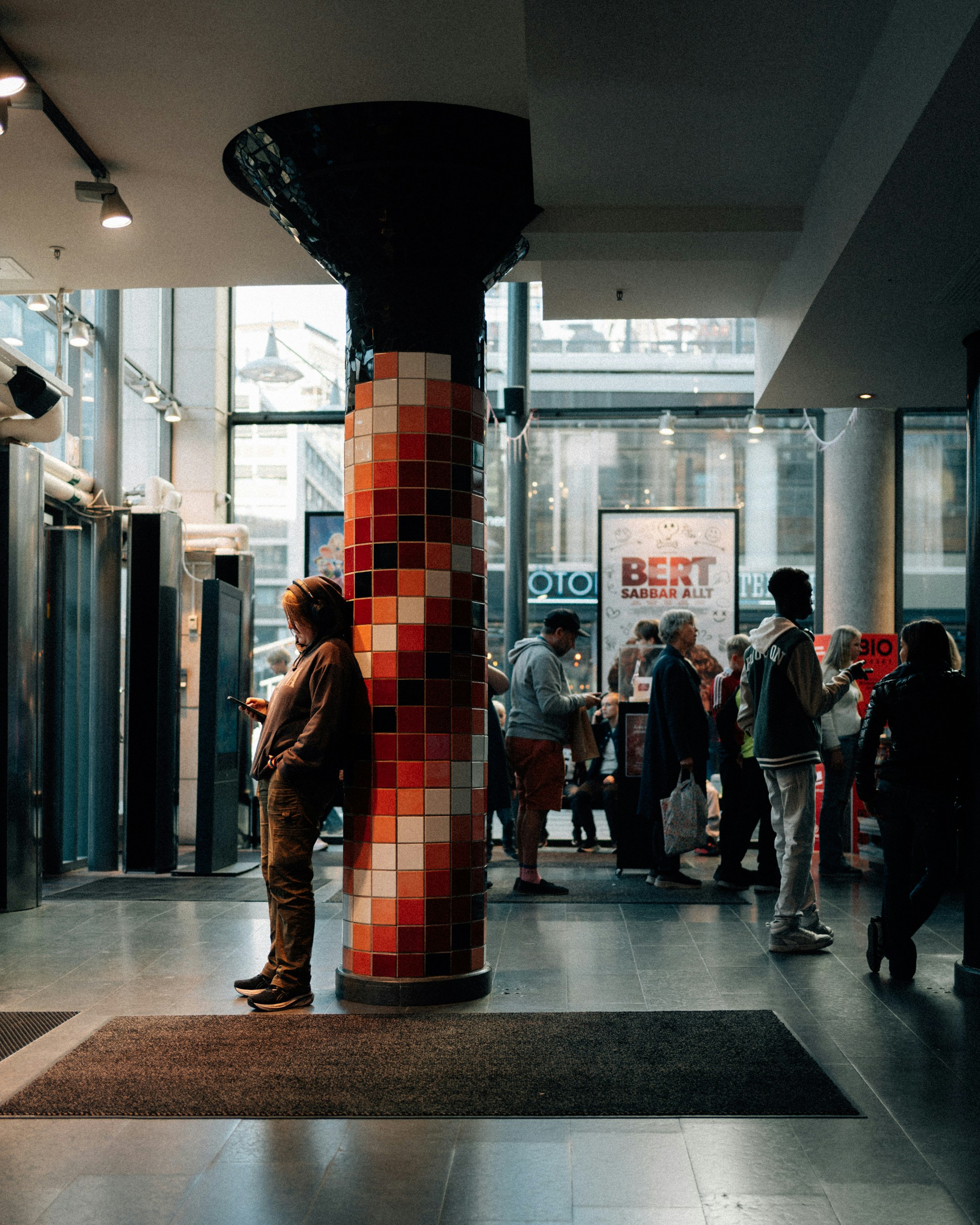 People gathered inside a modern building lobby