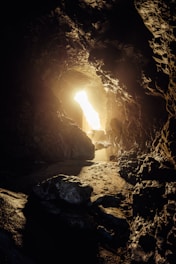 Bright light shines from a cave opening