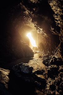 Bright light shines from a cave opening