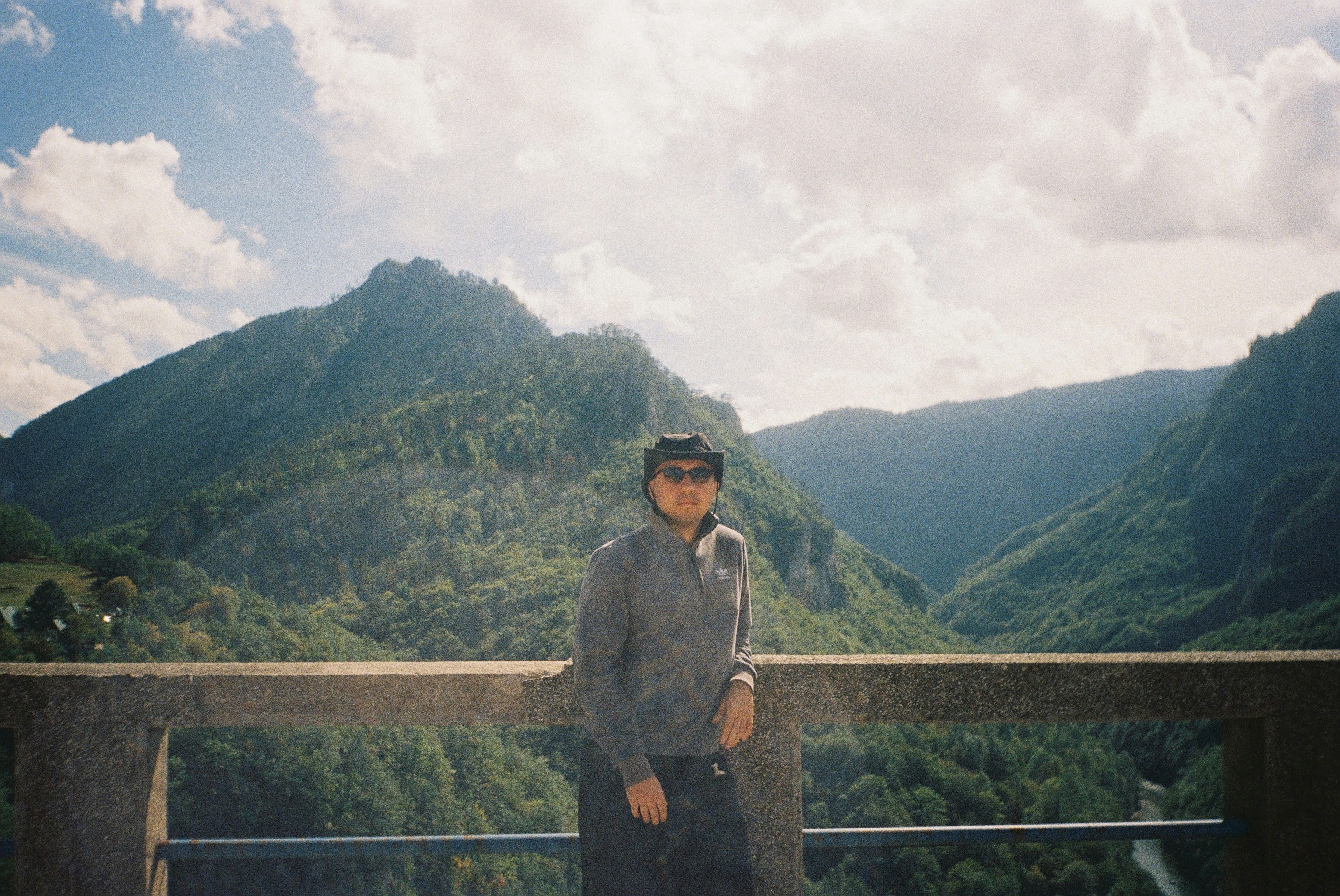 Woman standing with mountains and cloudy sky 풍경 사진