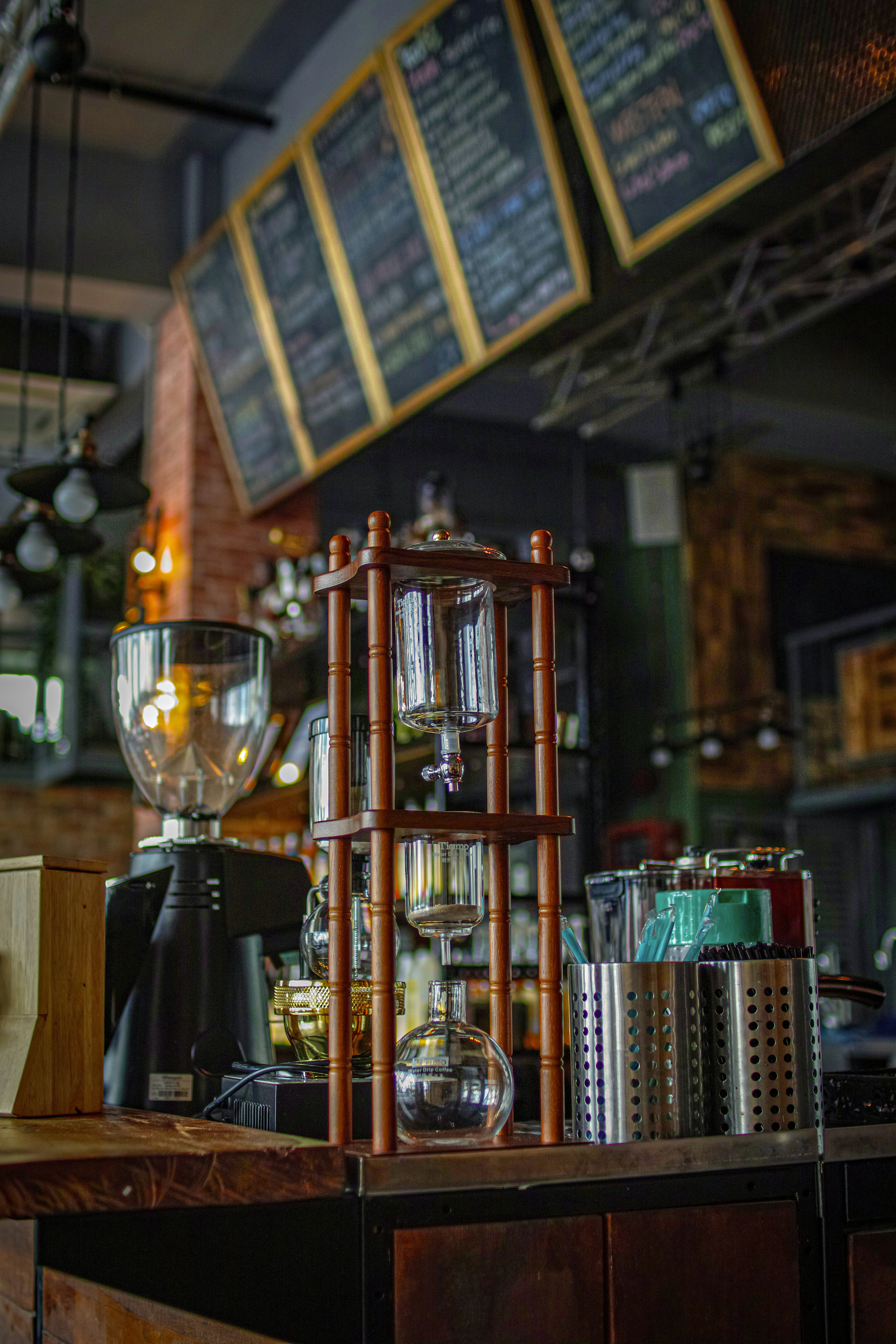 Cold brew coffee maker and grinder in cafe.
