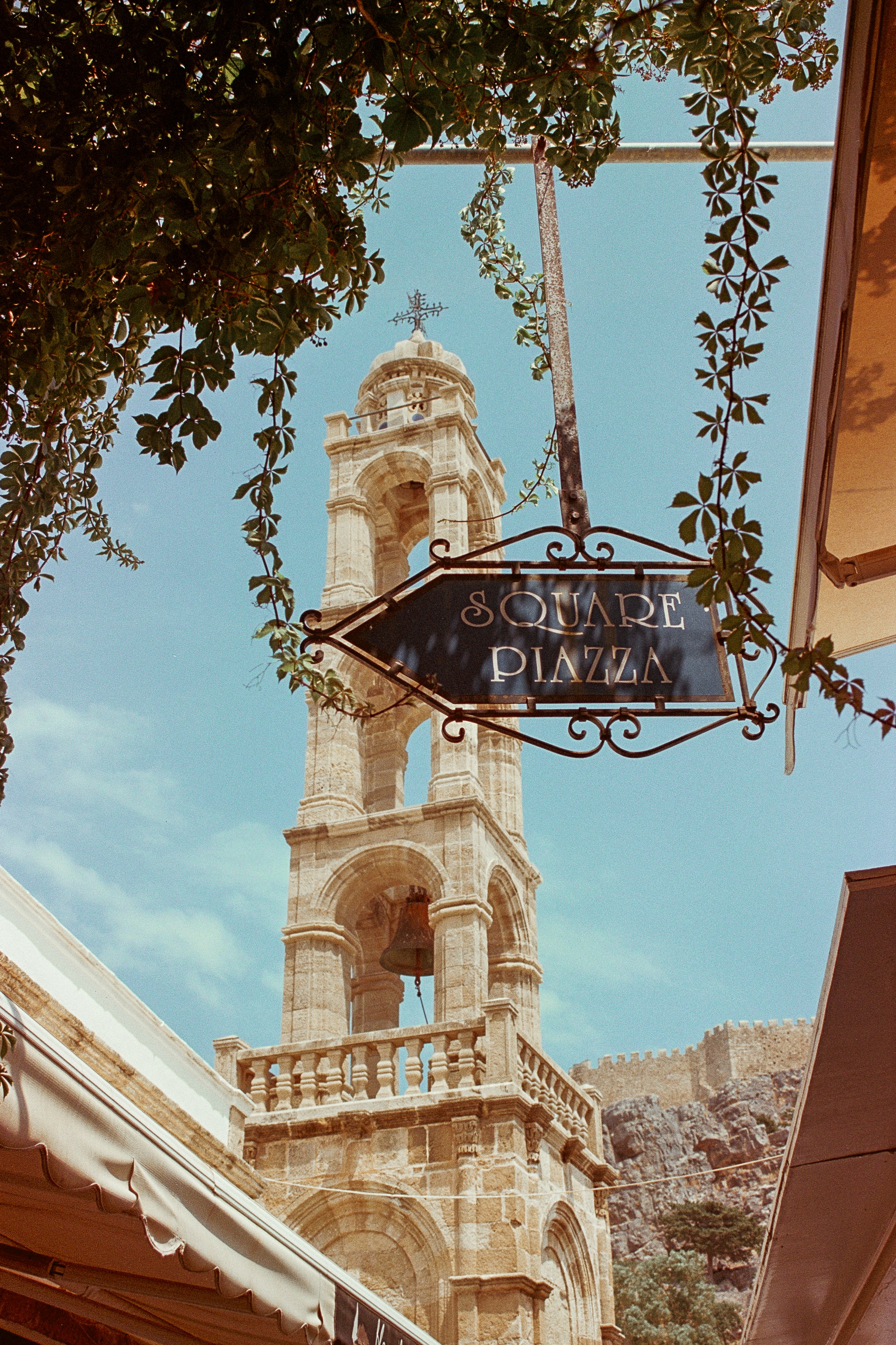 Bell tower with "square piazza" sign in a european town.