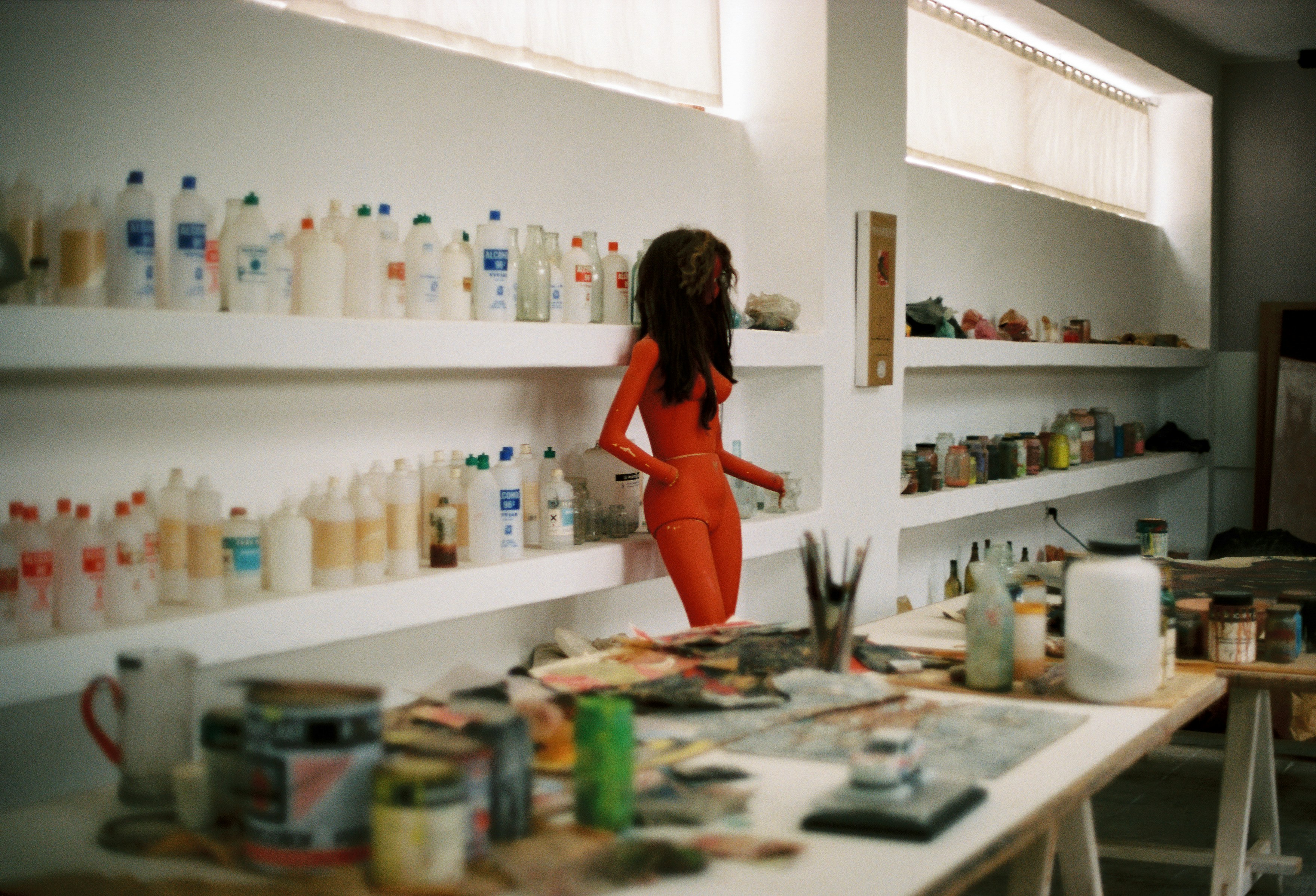 Woman in orange bodysuit in art studio