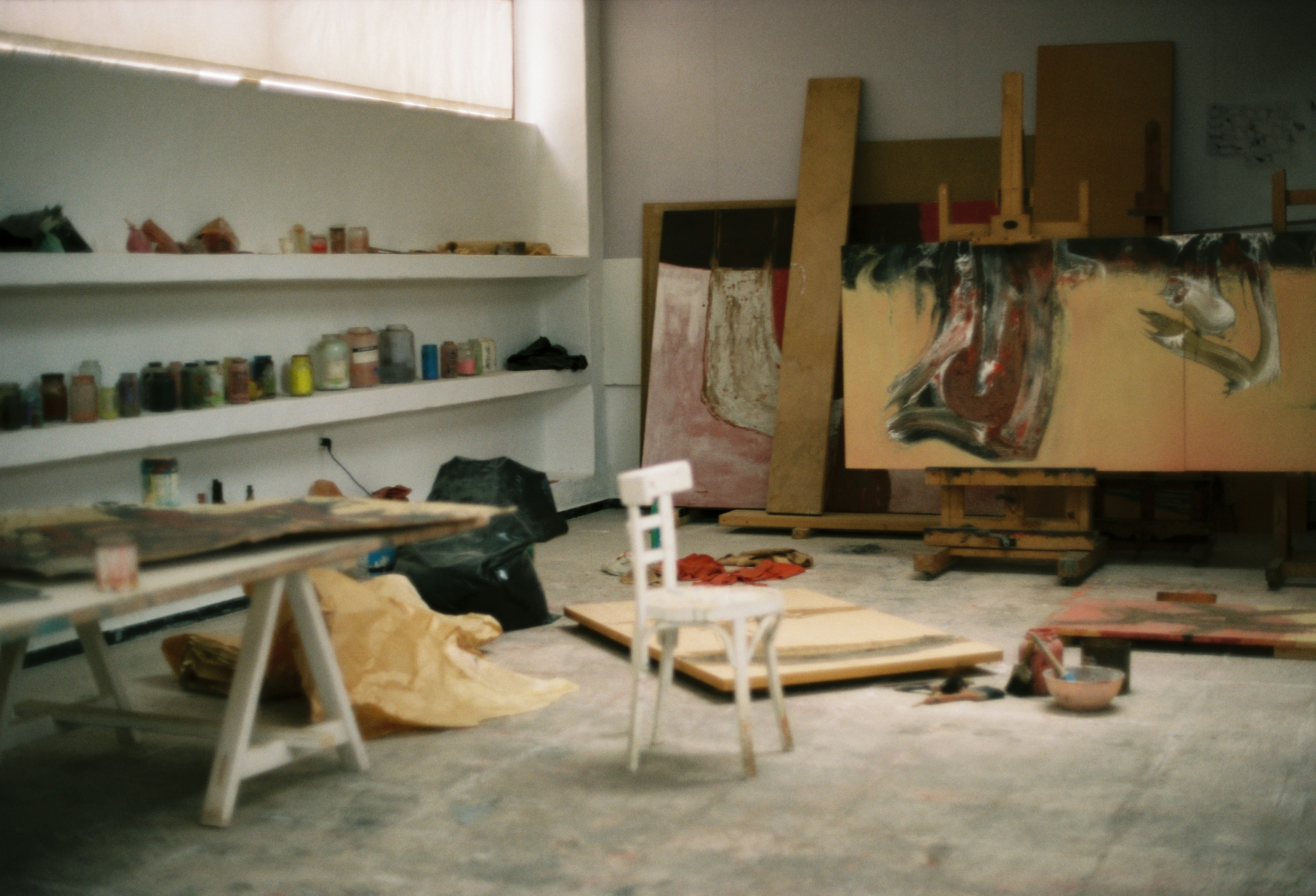 An artist's studio filled with paintings and supplies