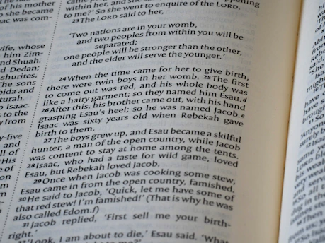 Close-up of an open bible with text visible.