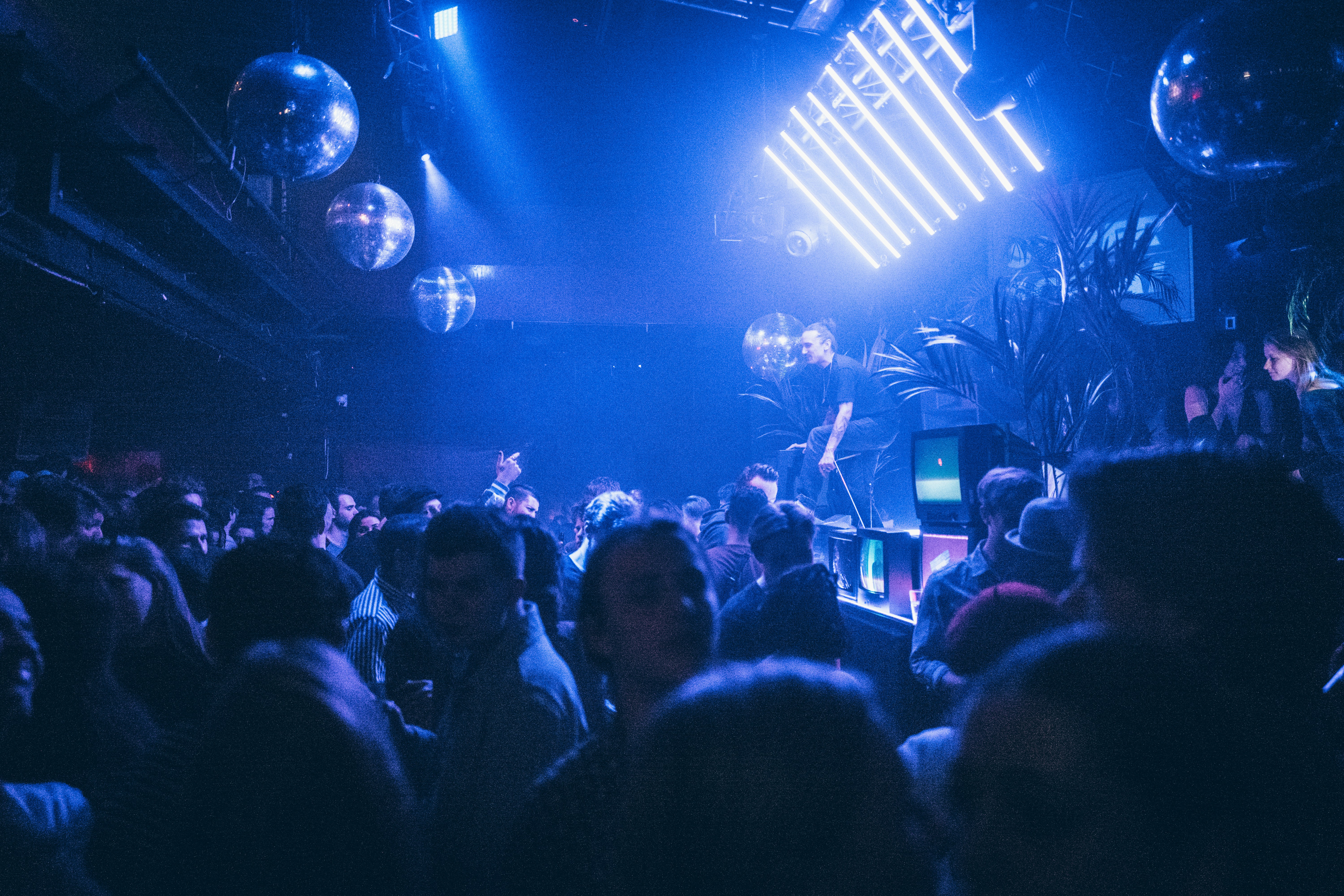 Crowd dancing under blue lights