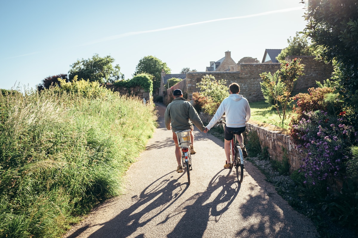 Two riders cruising a country bike path on a rental ride