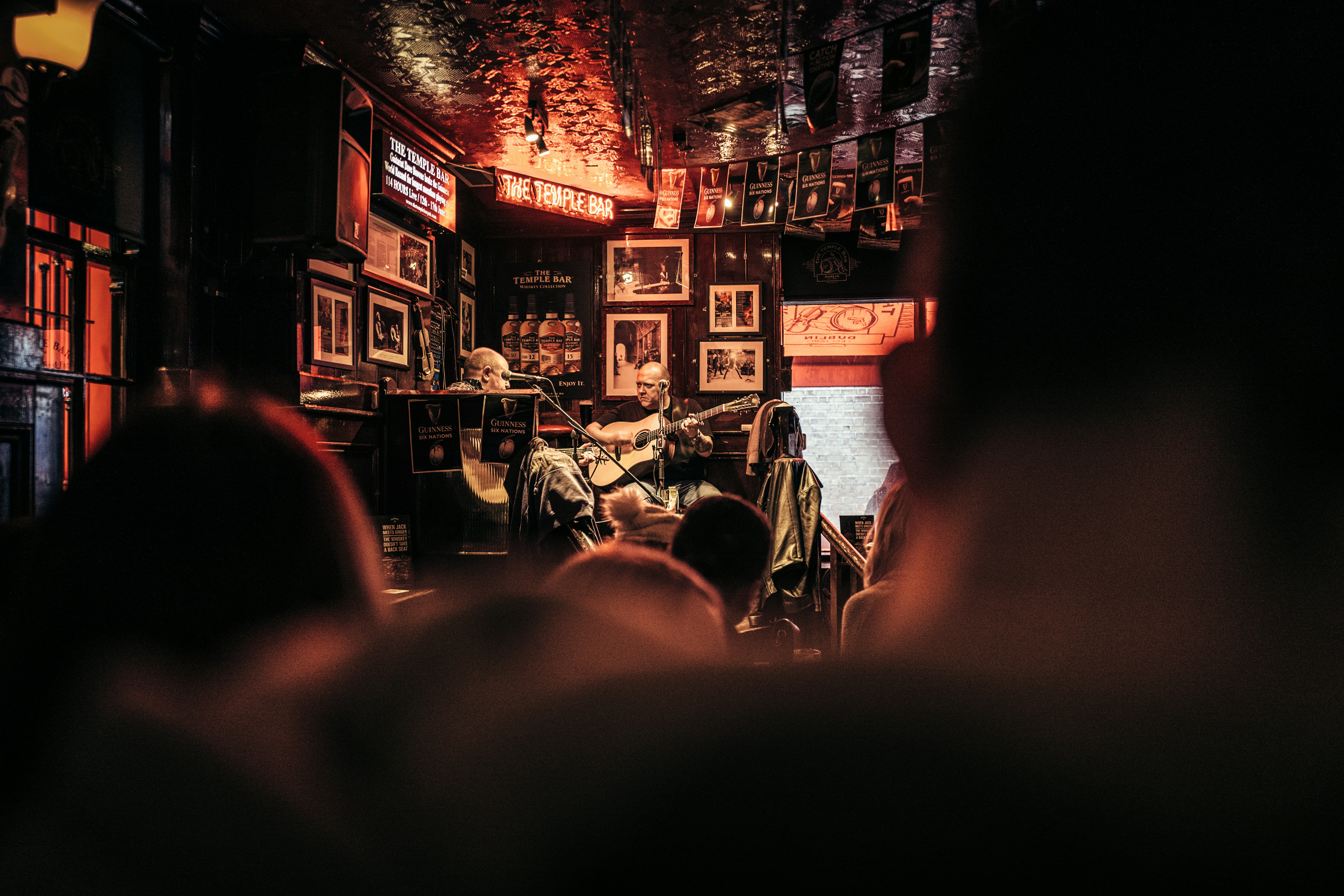 Musician performing in dimly lit, ornate bar