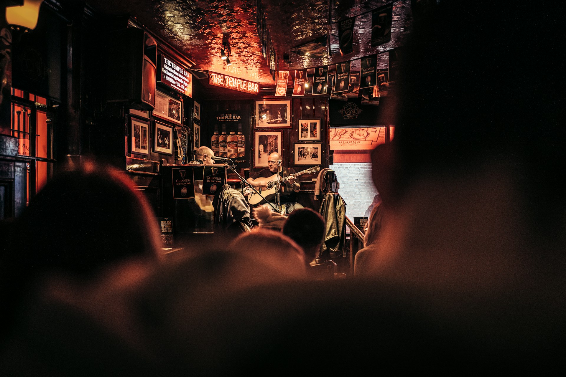 Musician performing in dimly lit, ornate bar