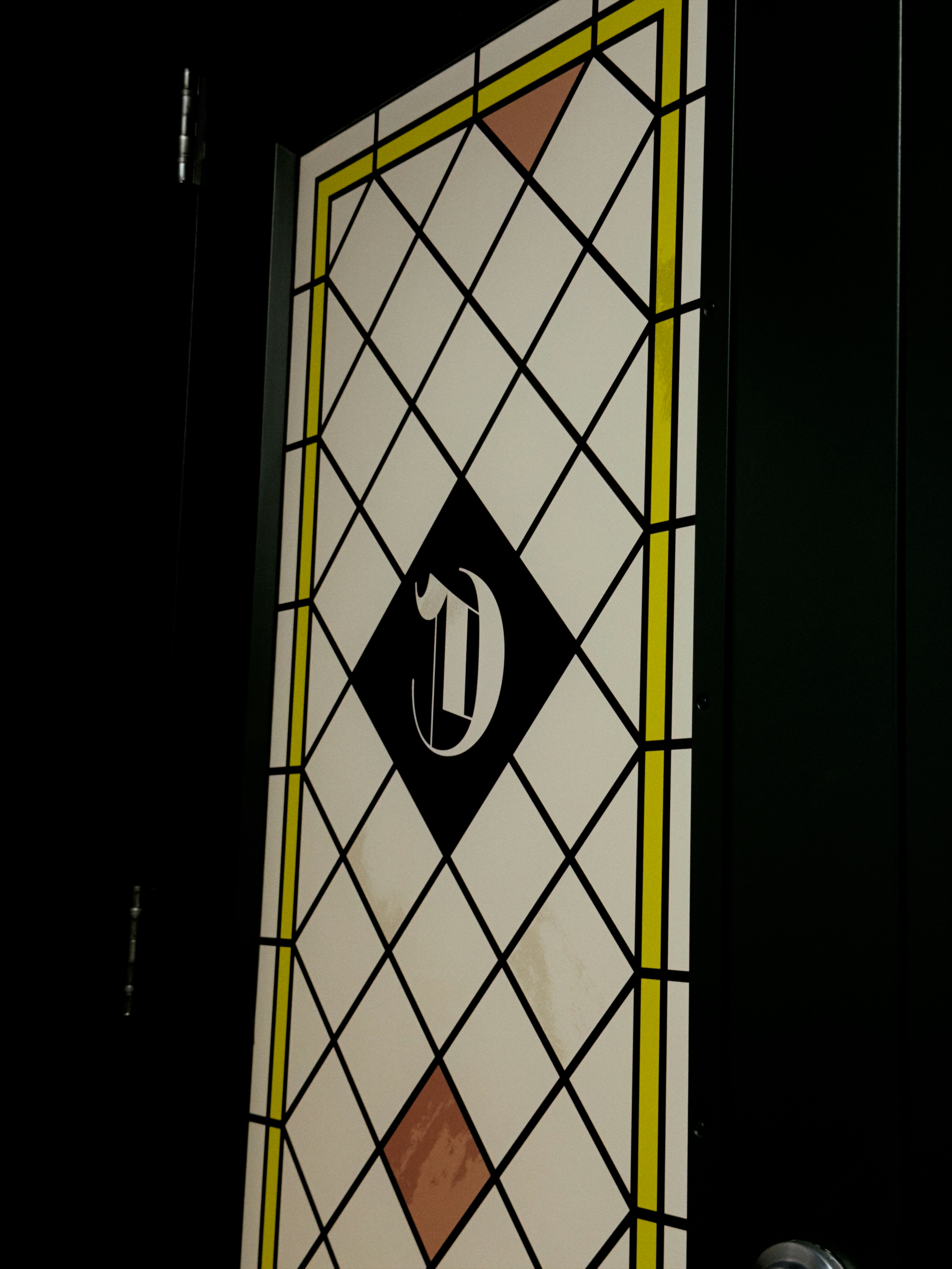 Diamond pattern with letter d on door