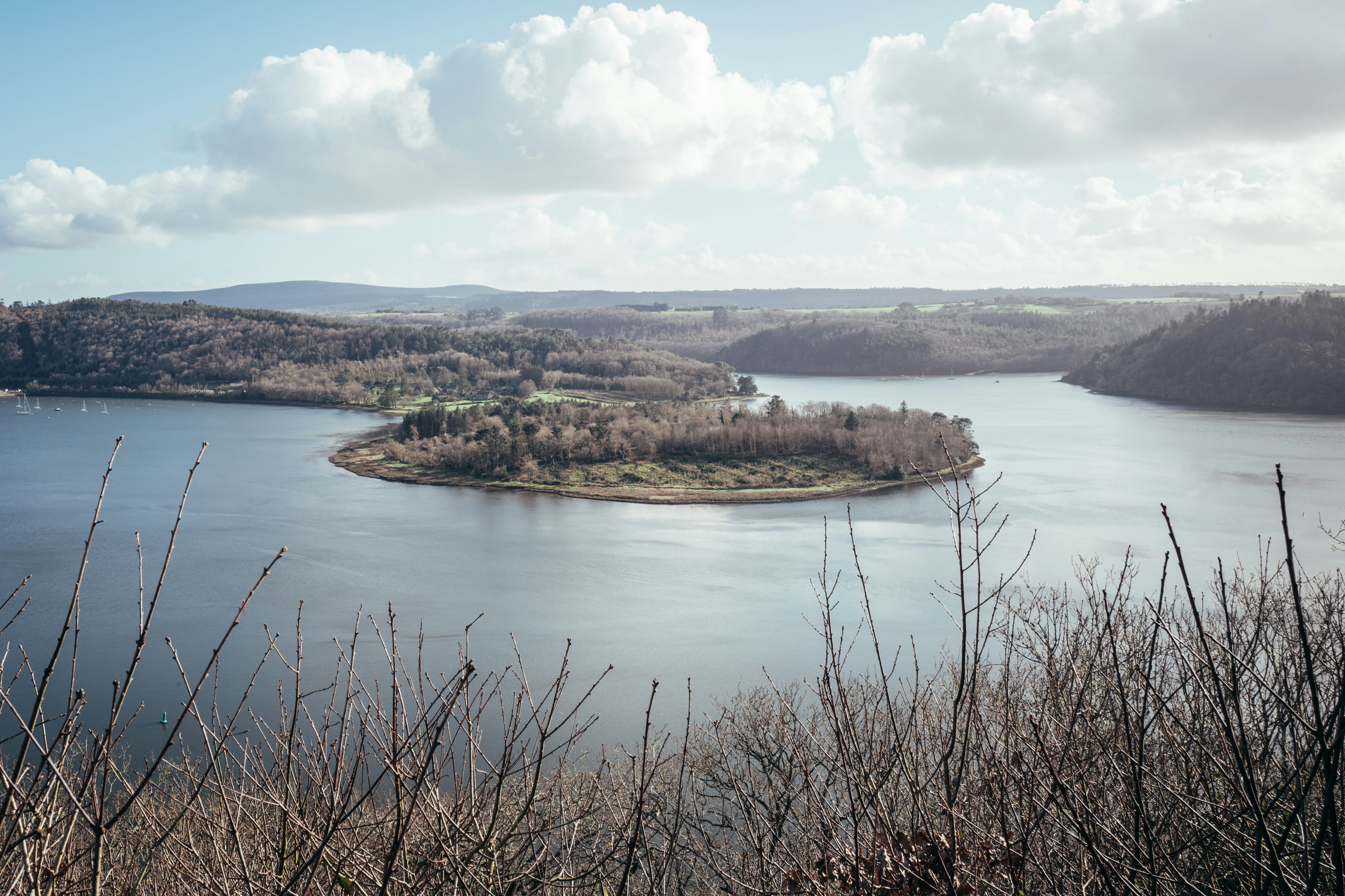 Island in a wide lake surrounded by hills