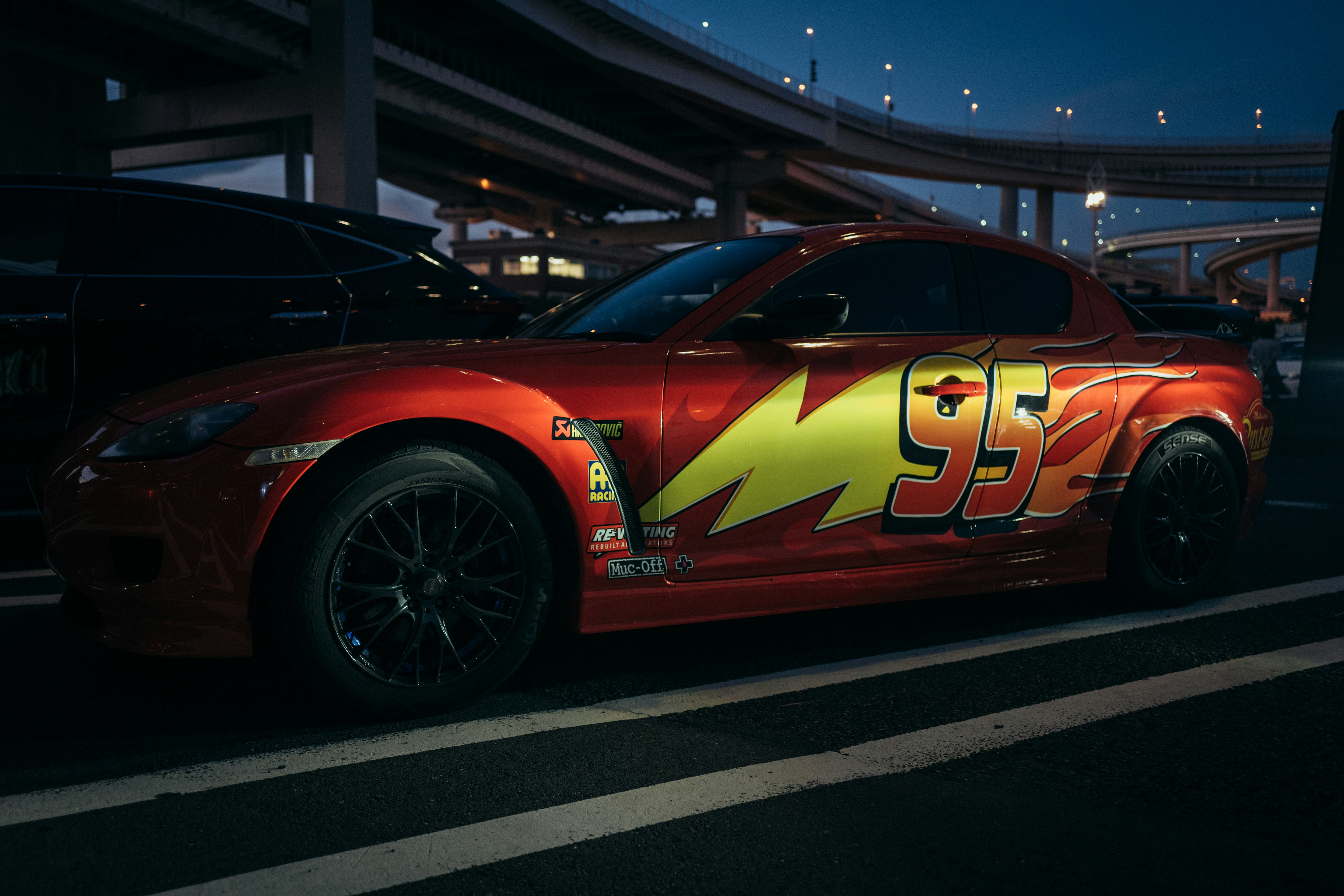 Red sports car with lightning bolt and number 95