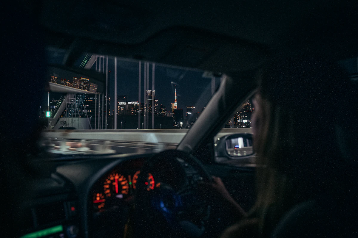 A driver's view of the city through the windscreen at night