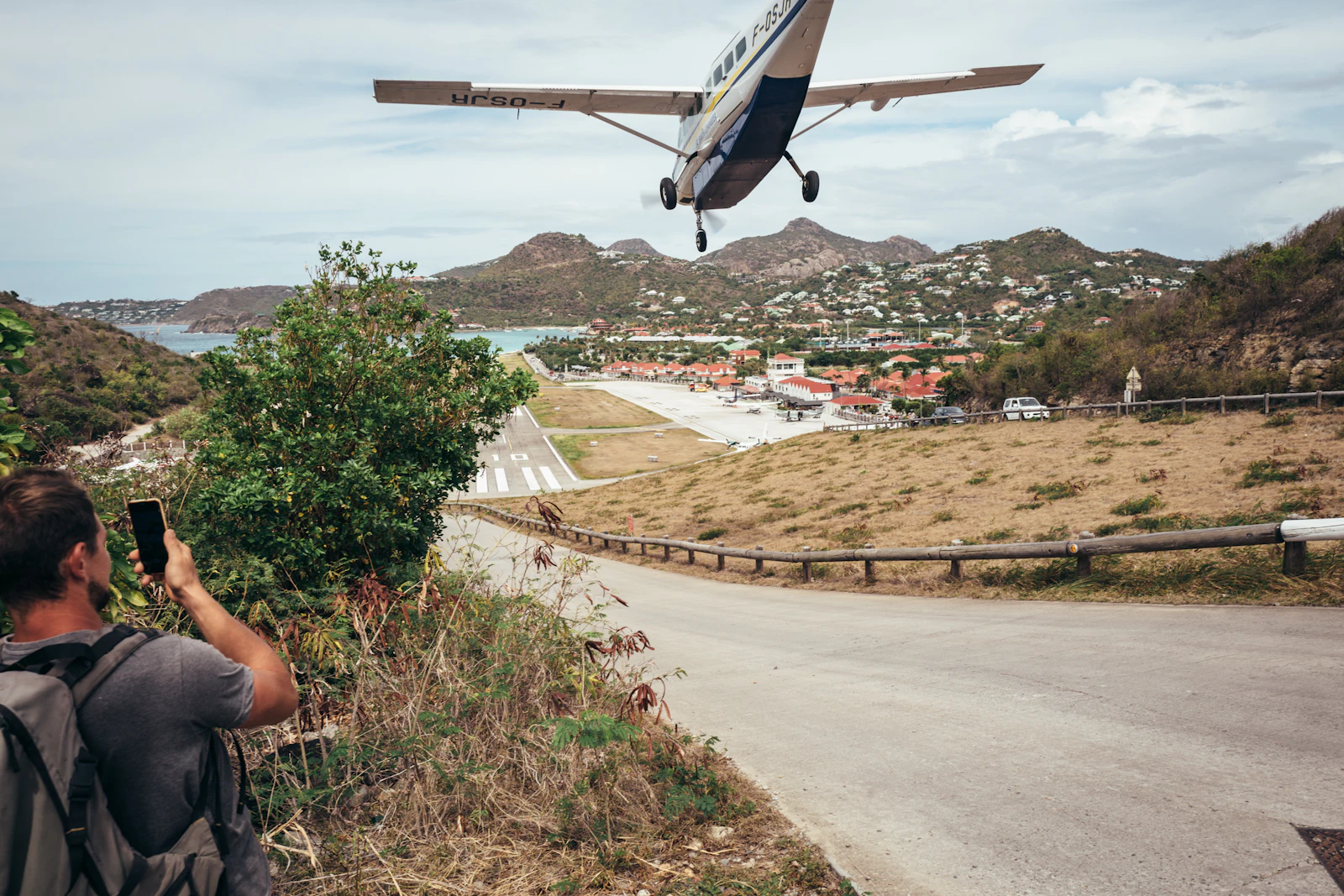 A small plane landing over the hill at St. Jean, Gustaf III Airport, St. Barts