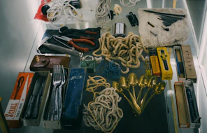 Collection of vintage tools and cutlery laid out utensils
