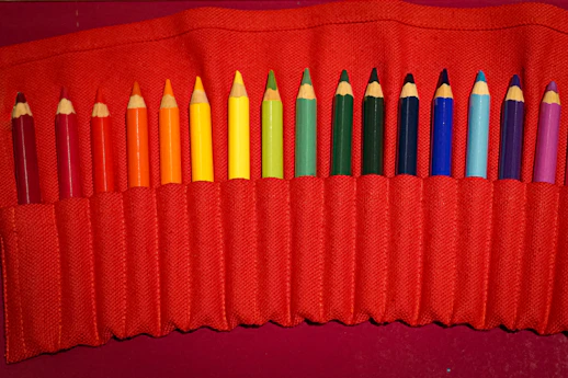 Colored pencils arranged in a red roll-up case