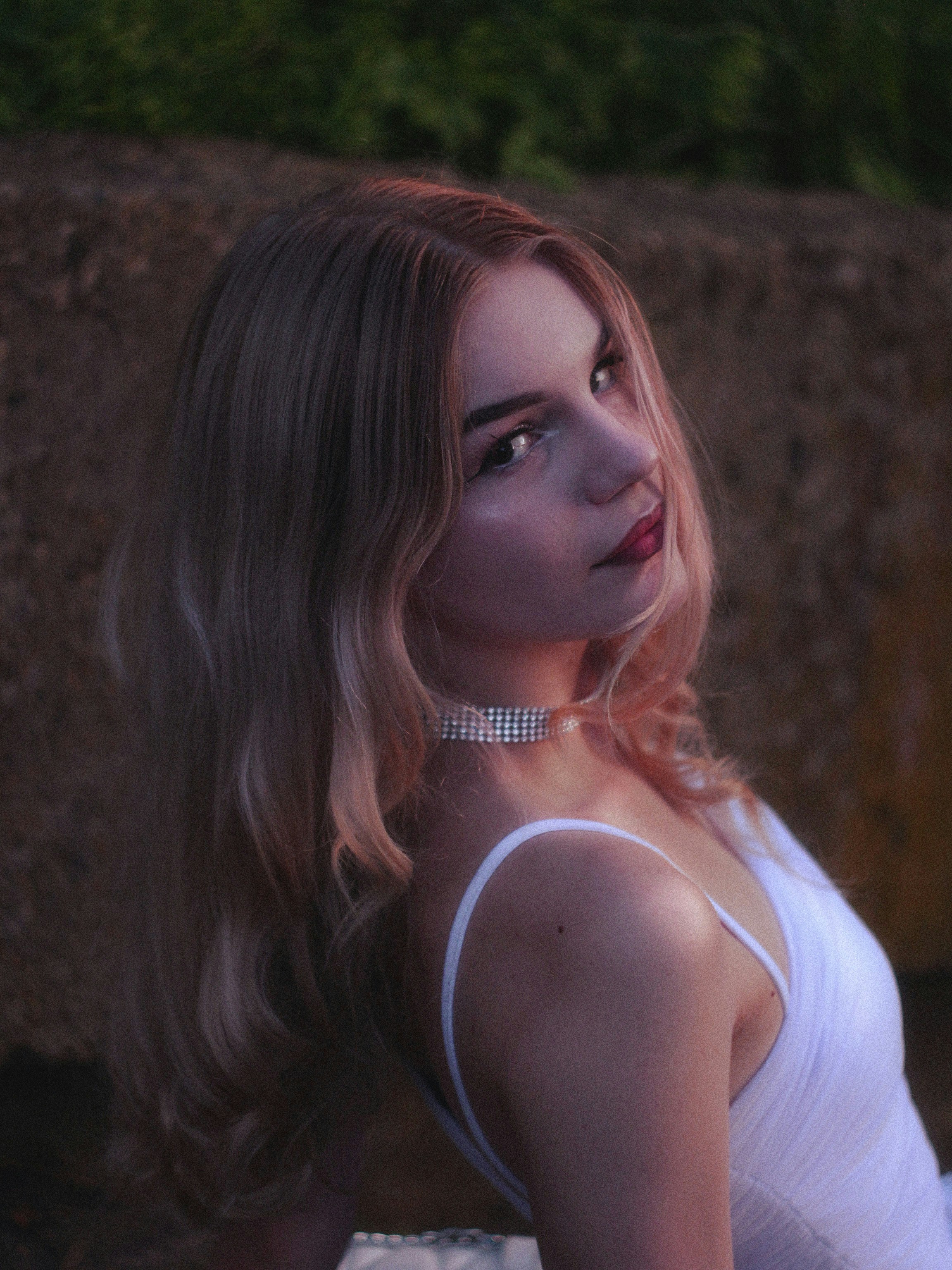 Young woman with blonde hair wearing white dress