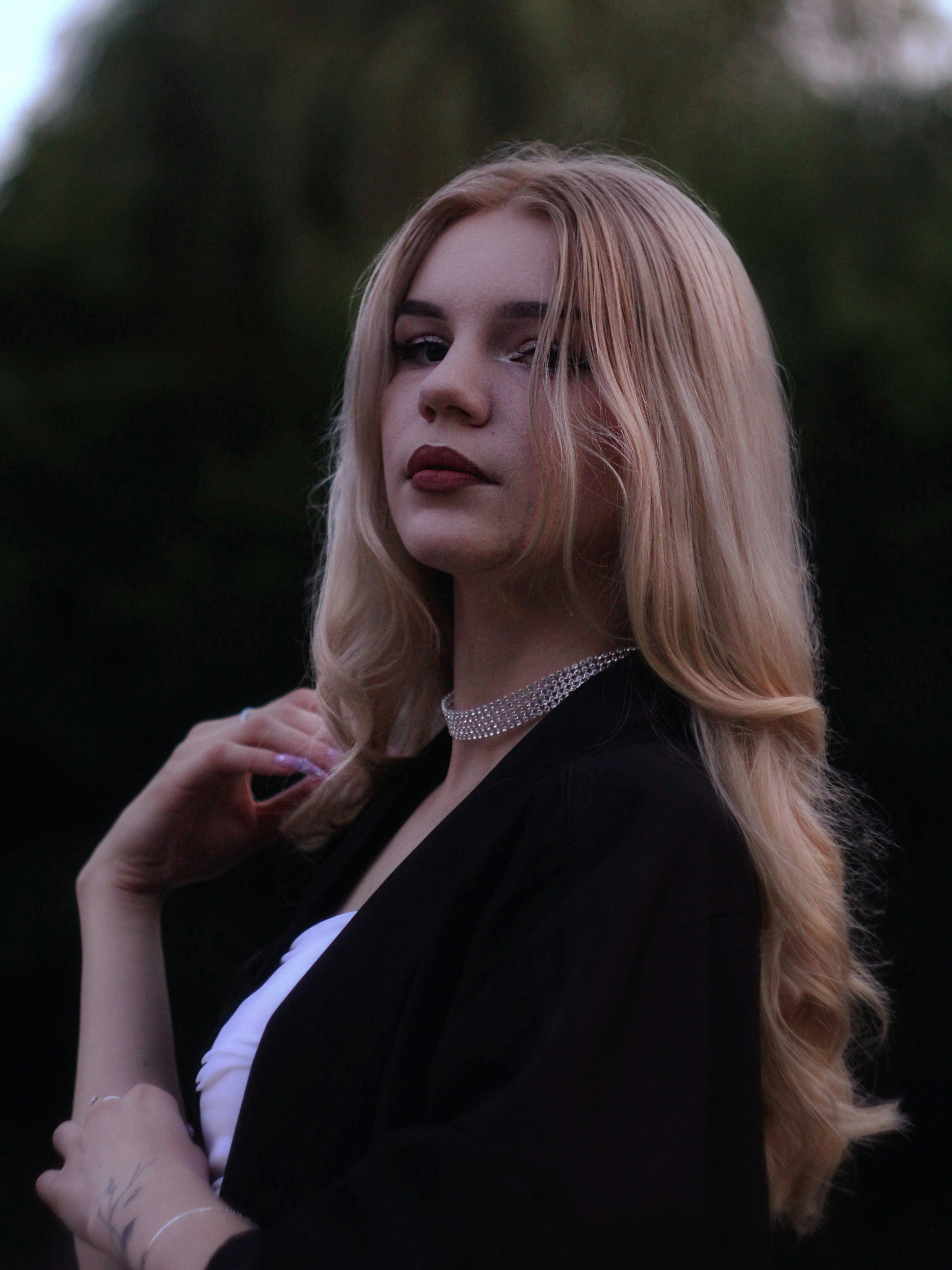 Young woman with blonde hair wearing a necklace