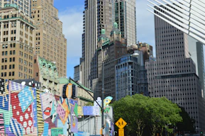 Colorful mural on a city street with skyscrapers