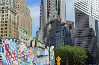 Colorful mural on a city street with skyscrapers