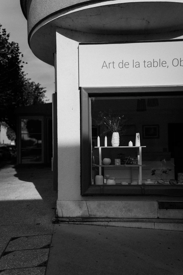 Handmade ceramic pieces displayed in a bright shop window