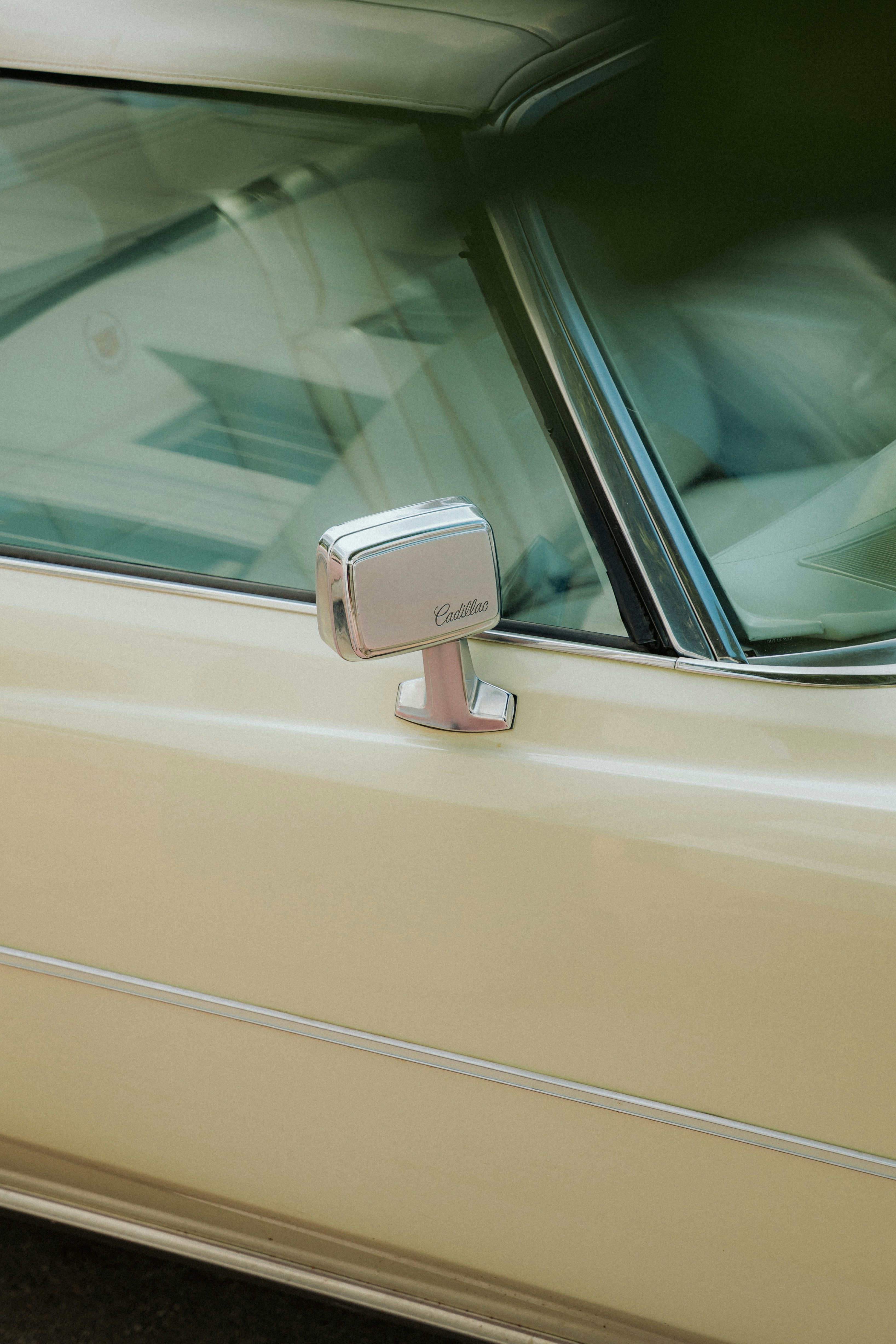 Close-up of a vintage car's side mirror.