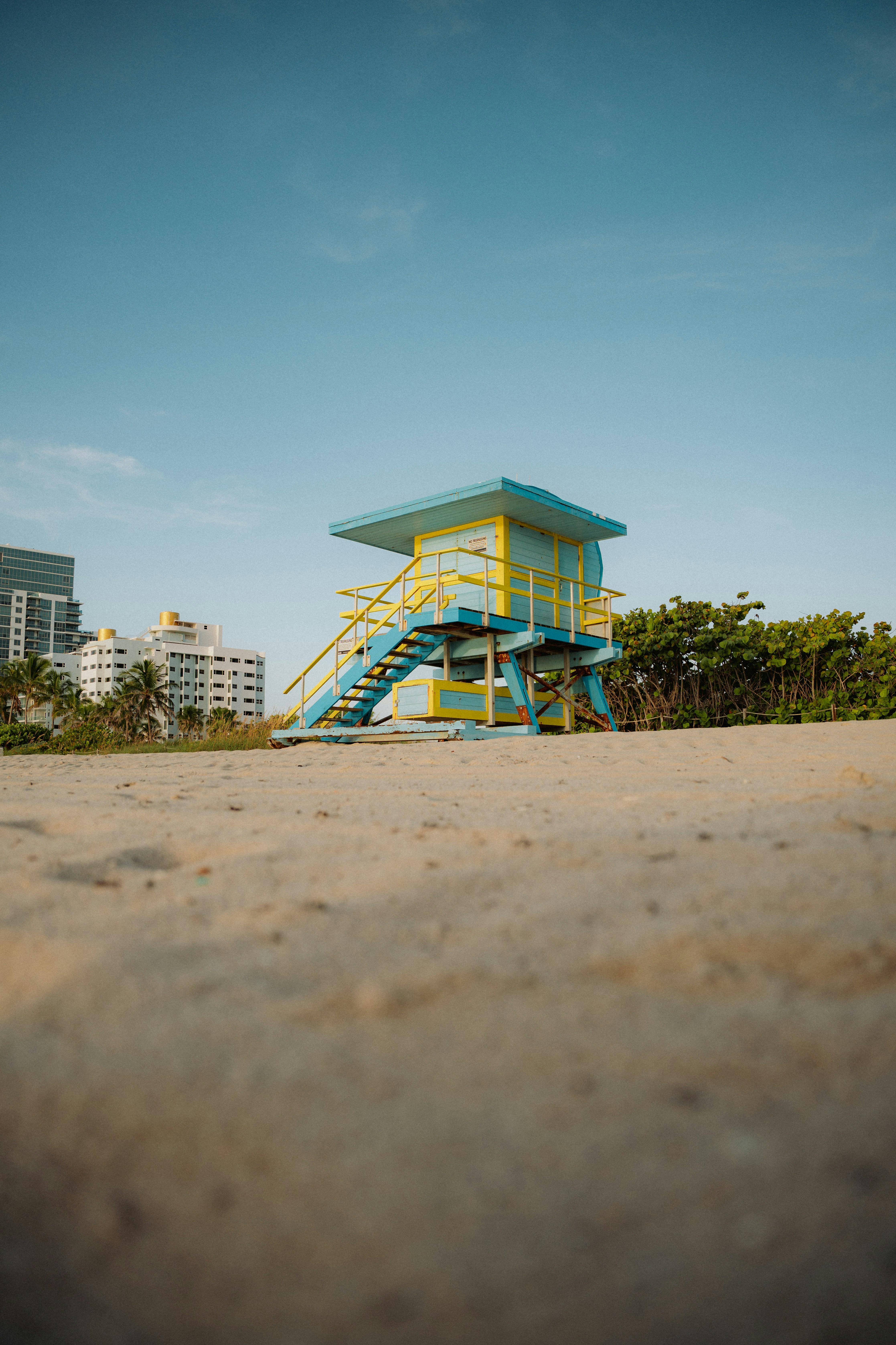 Colorful lifeguard tower on a sandy beach.