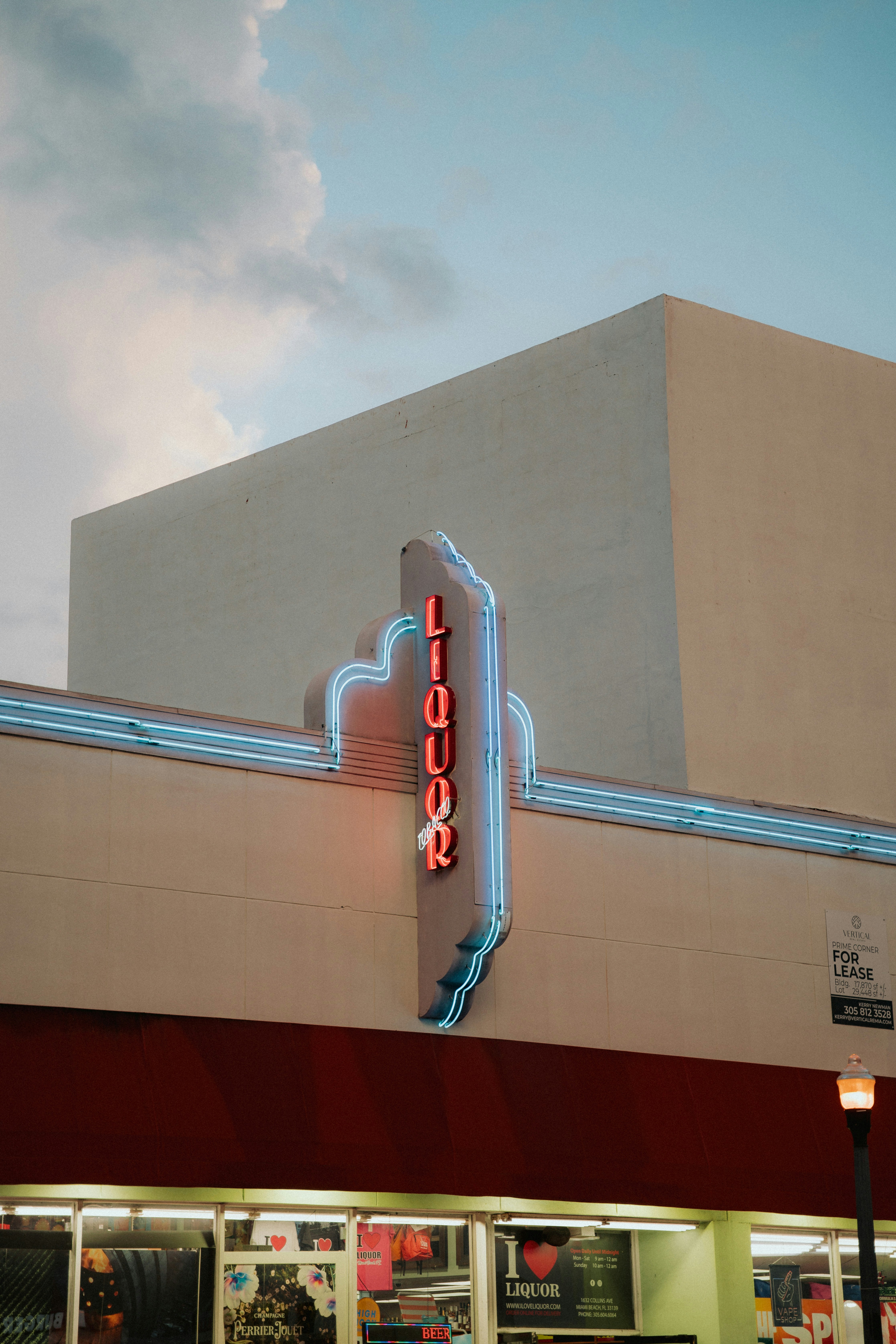Liquor store sign with neon blue and red lights.