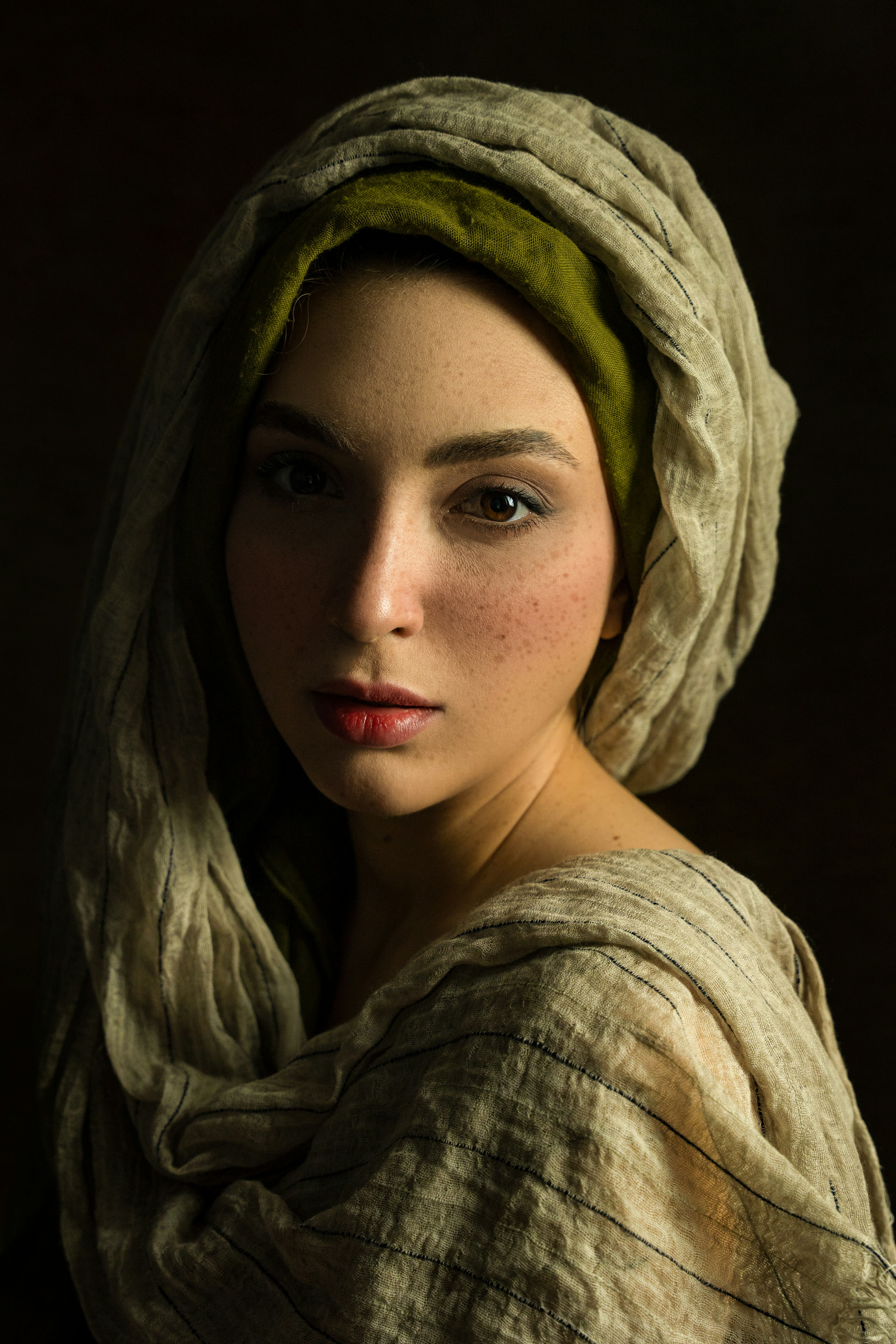 Young woman with headscarf and freckles