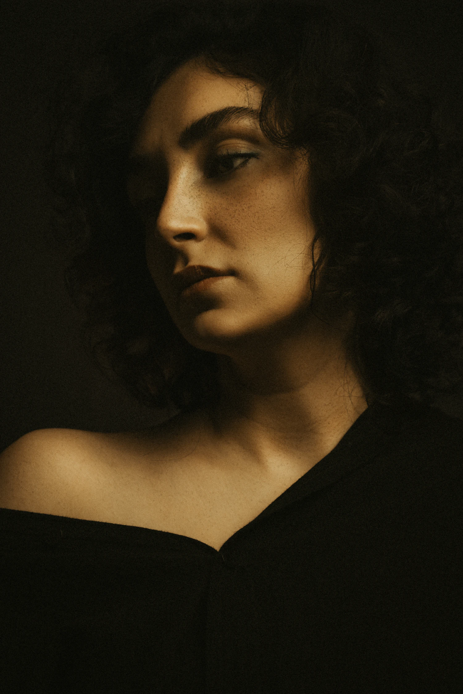 Marguerite Dulac, photographed against the dark wall of her studio