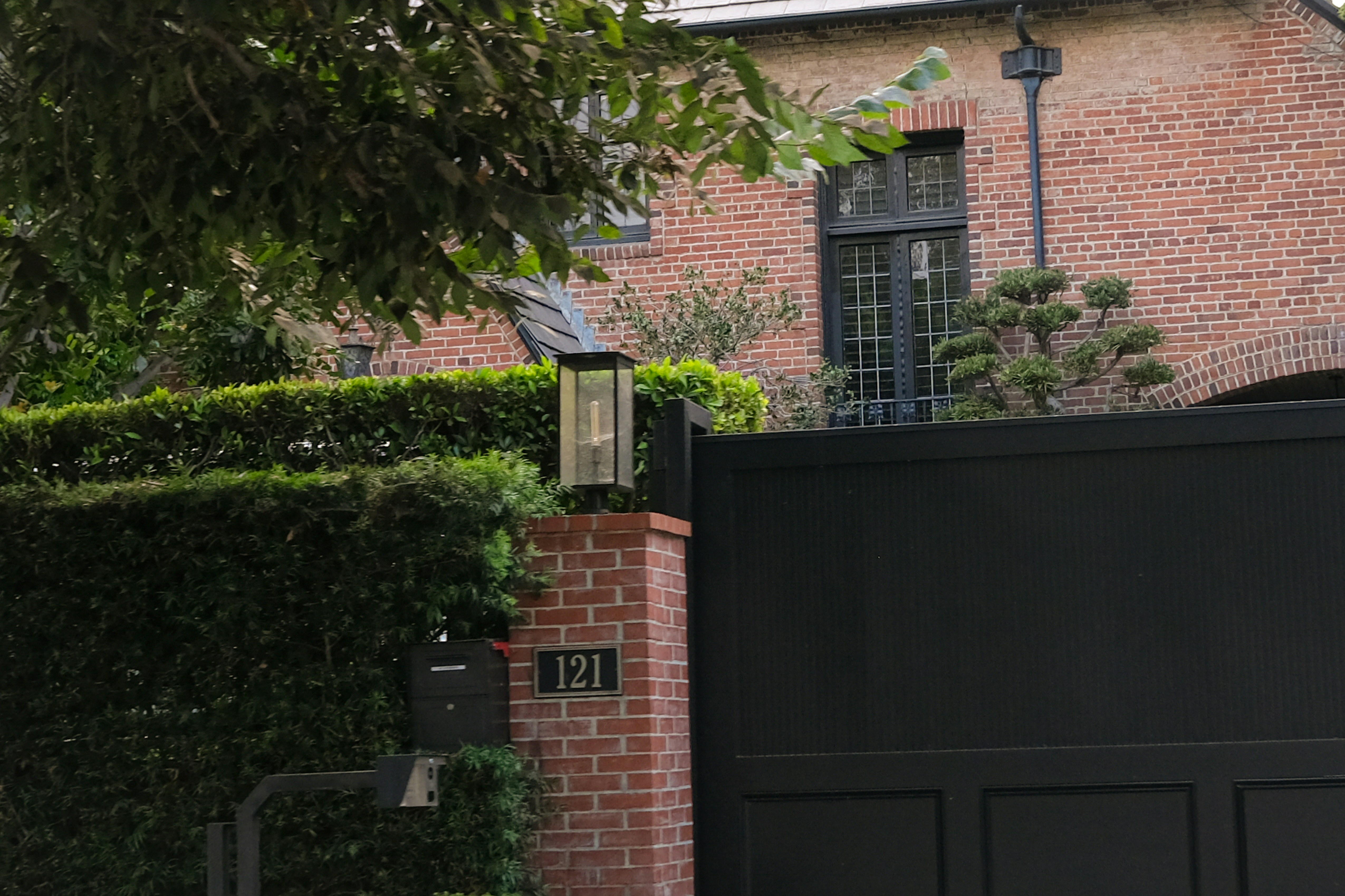 Brick house with a large black gate.