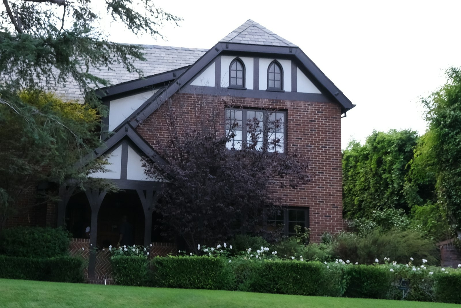 Two story brick home with divided light windows and mature landscaping, the kind of east side Cincinnati house that shapes a window cleaning quote