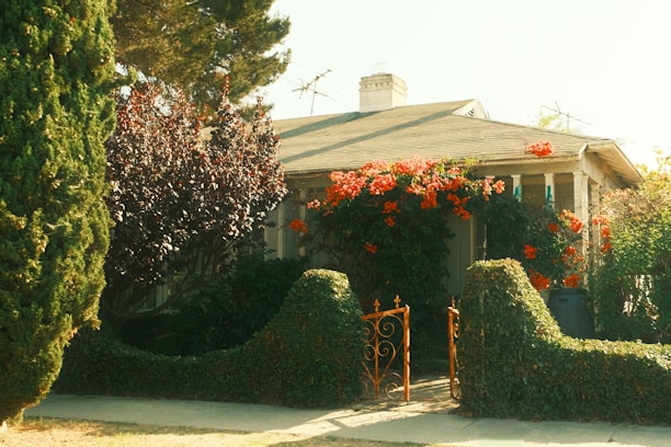 A charming house with blooming red flowers and orange flowers.