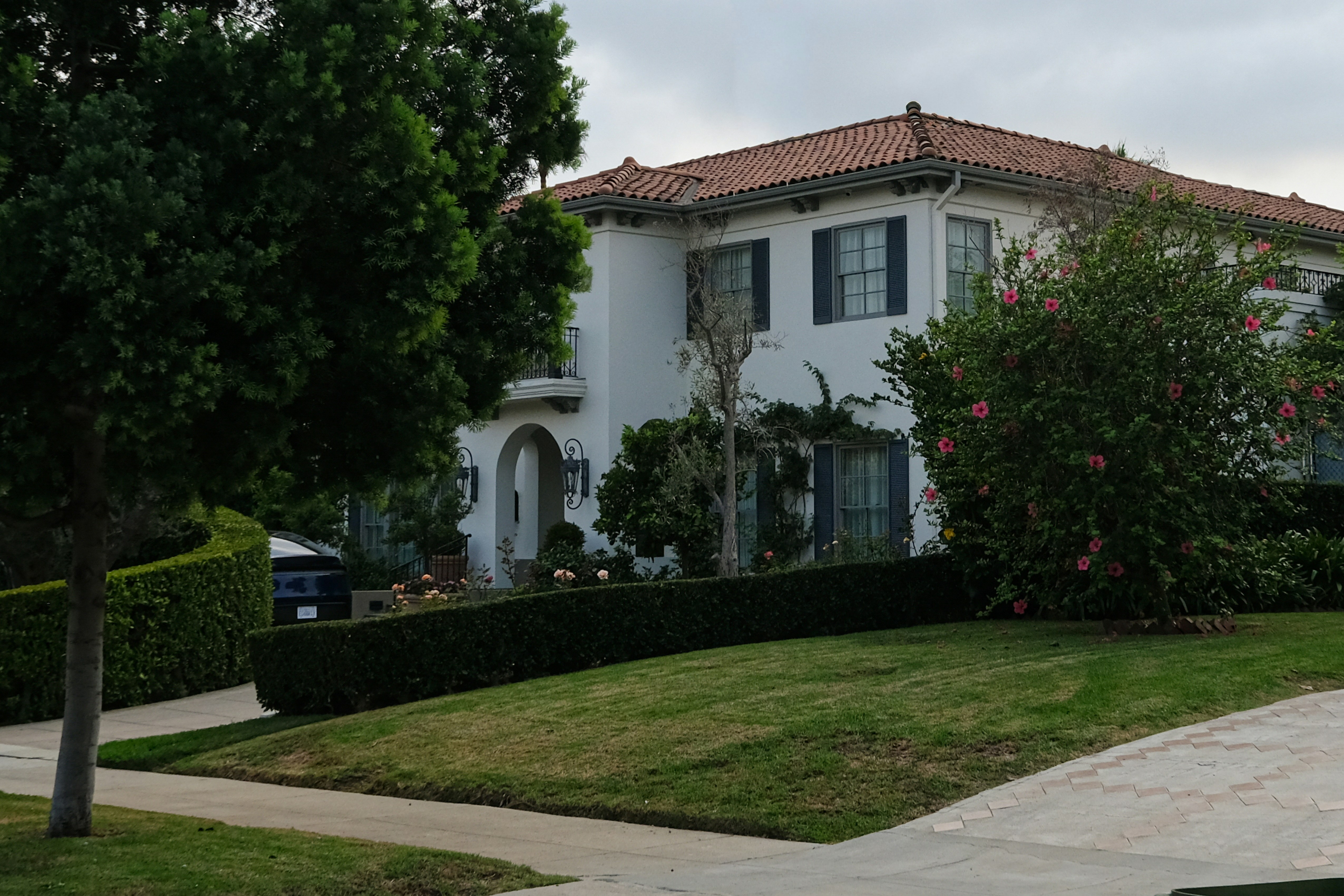 Large white mansion with tiled roof
