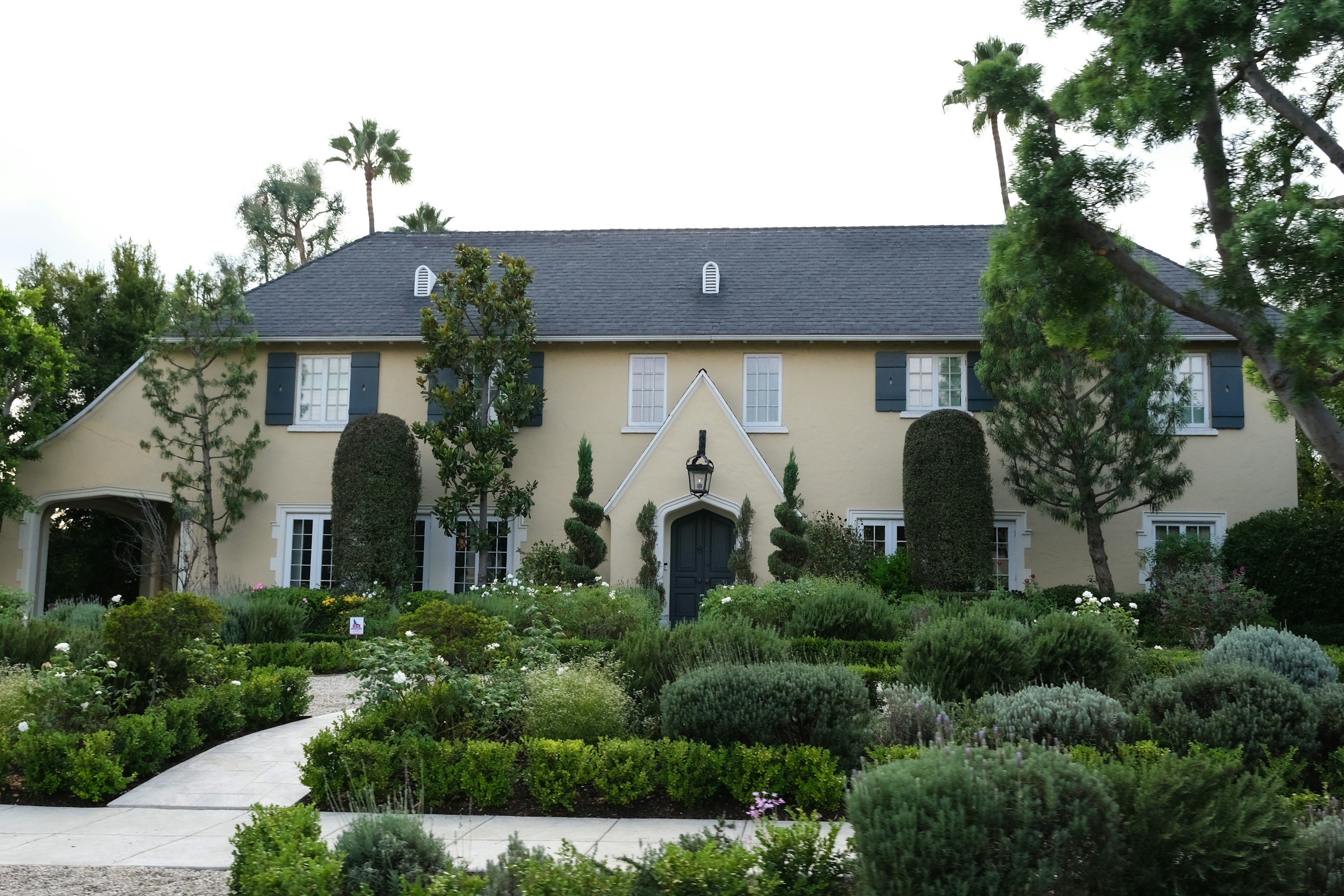 Luxury California estate with manicured gardens and palm trees