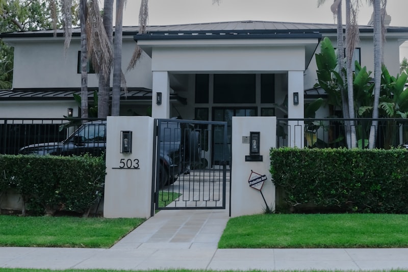 Modern residential entry gate with manicured landscaping