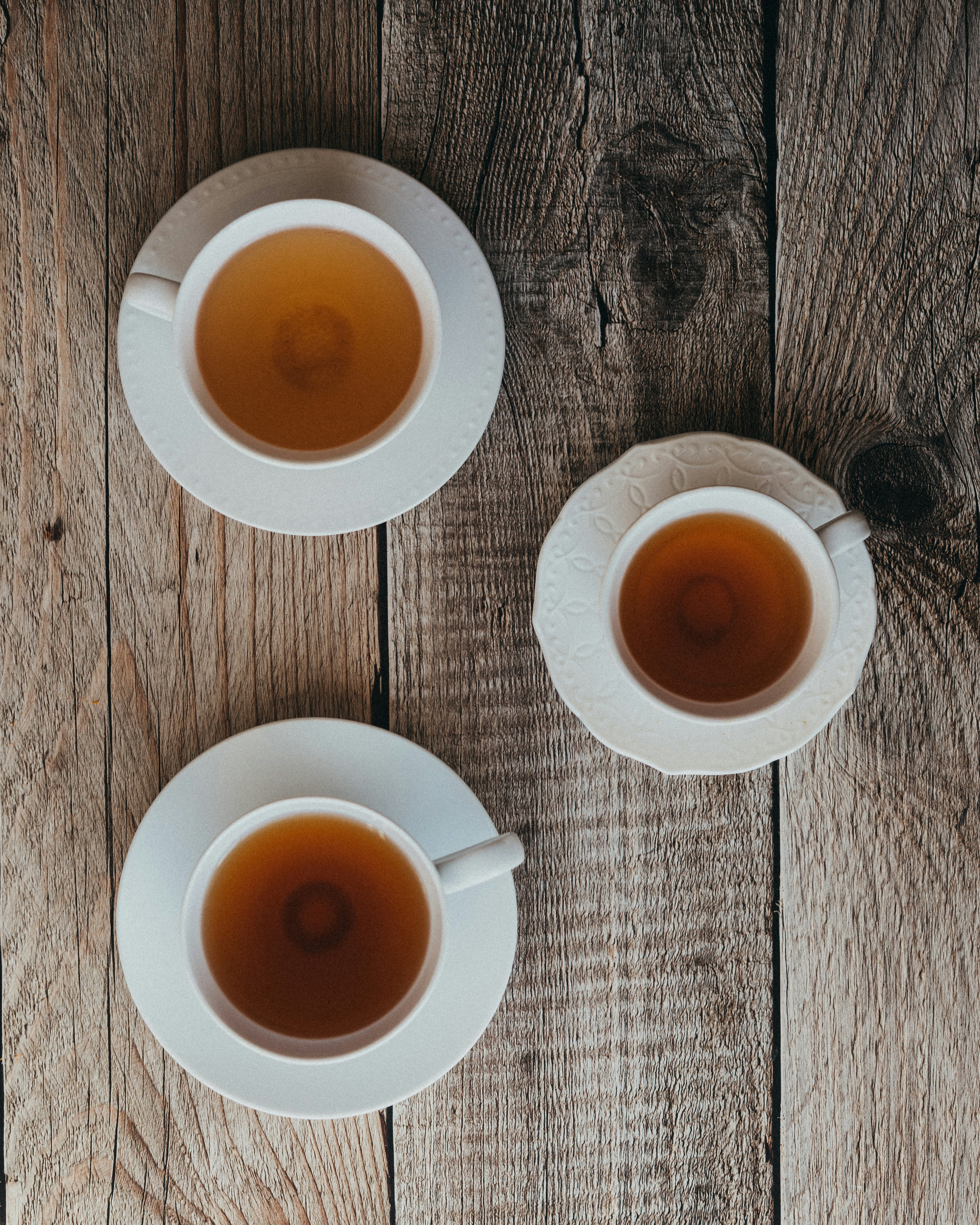 Three cups of tea on a wooden table
