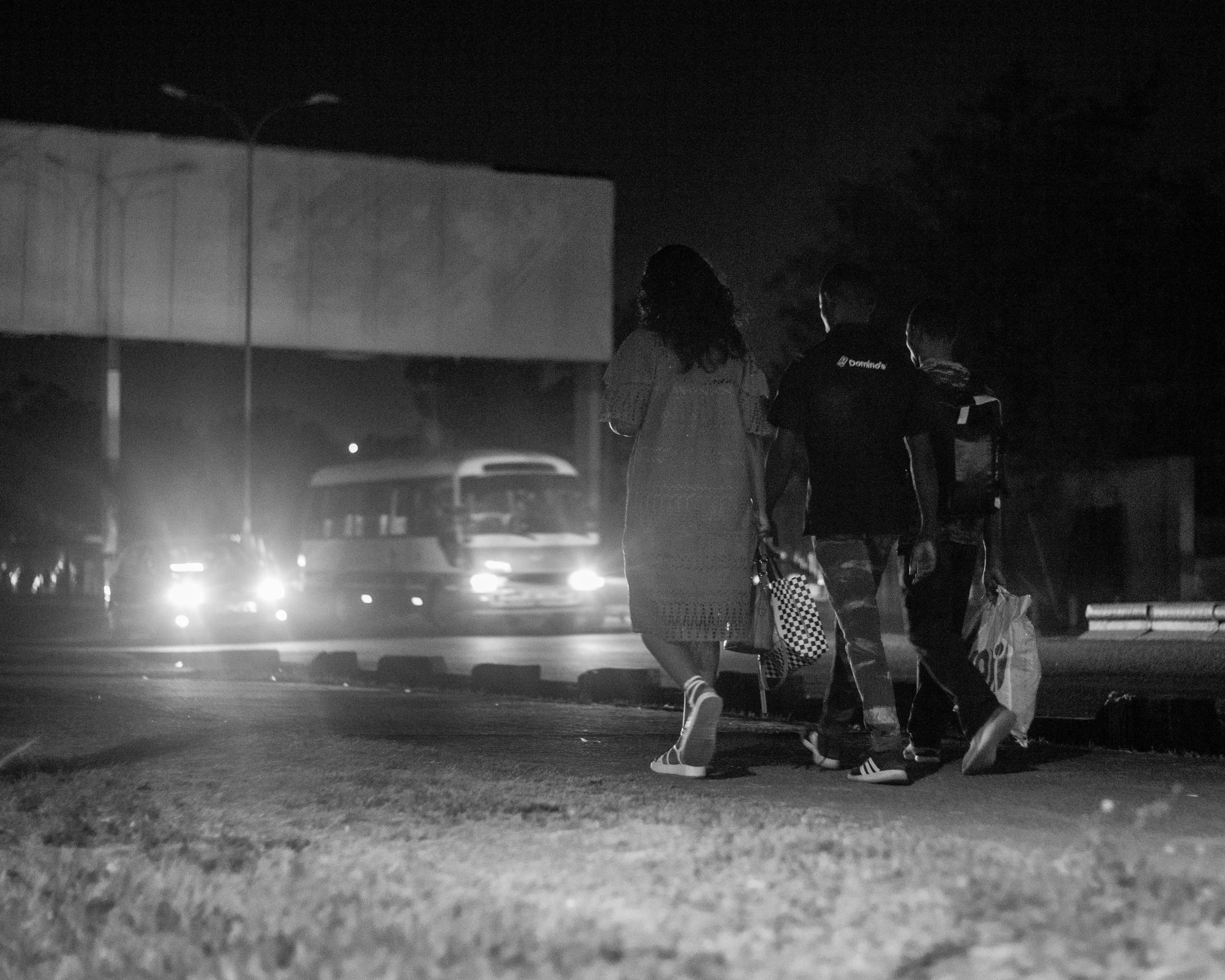 एक गरीब रसोई में एक महिला खाली गैस सिलेंडर को चिंतित मुद्रा में देख रही है, पास में कुछ बर्तन पड़े हैं।