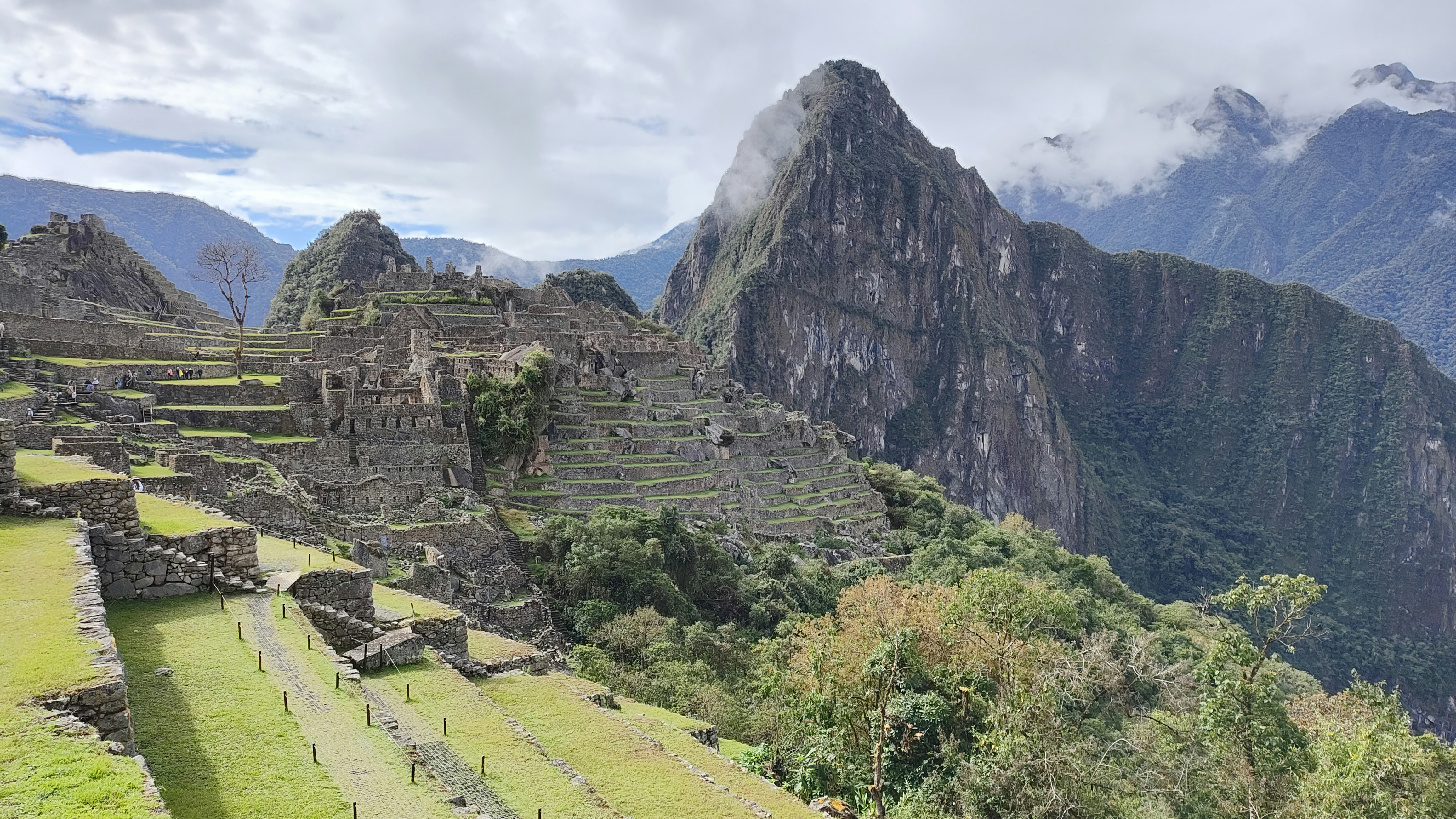 Tourists exploring Machu Picchu ruins