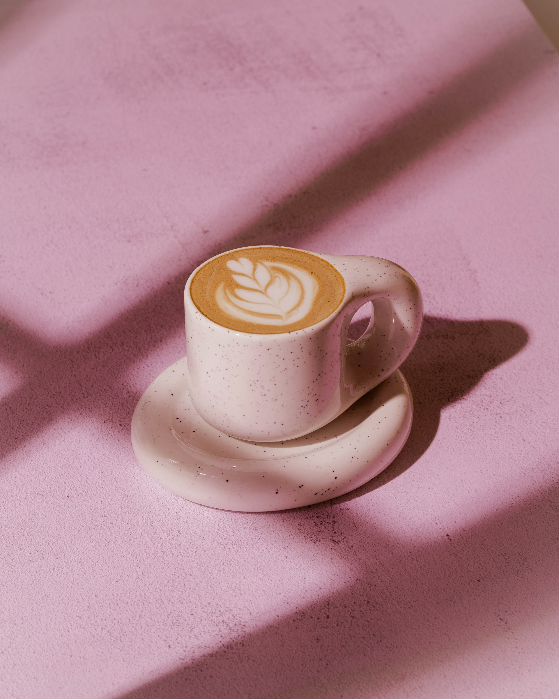 A small cup of coffee with latte art.